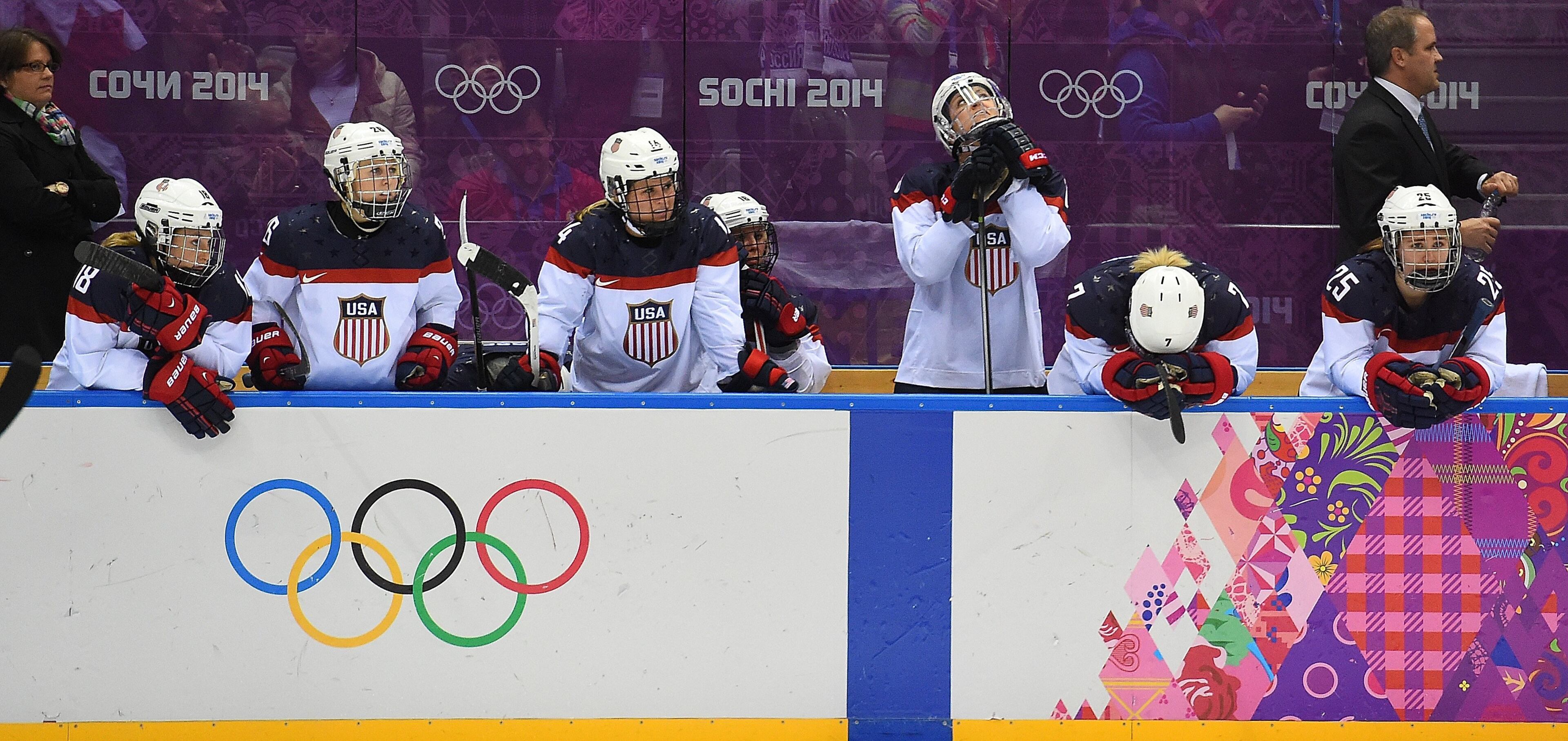USA players watch as Canada players celebrate their victory in overtime of the women's Gold Medal hockey game at the Winter Olympics in Sochi, Russia, Thursday, February 20, 2014. Canada defeated USA 3-2 in overtime to win the Gold Medal. (Harry E. Walker/MCT)