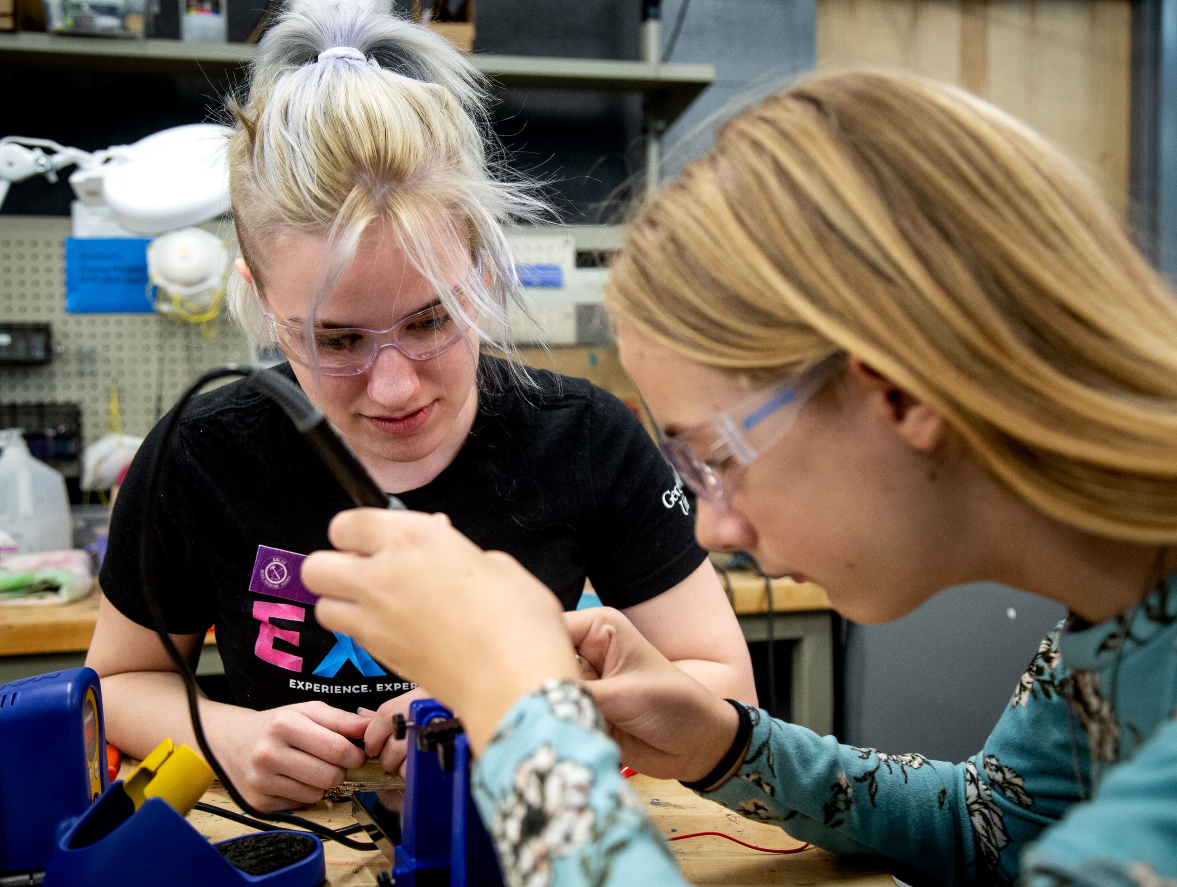Mikaila Keel (R) helps Josephine Kean with her soldering on a project she's working on during the Genius Camp in the ExLab at Georgia State University on Saturday, March 7, 2020. STEVE SCHAEFER / SPECIAL TO THE AJC