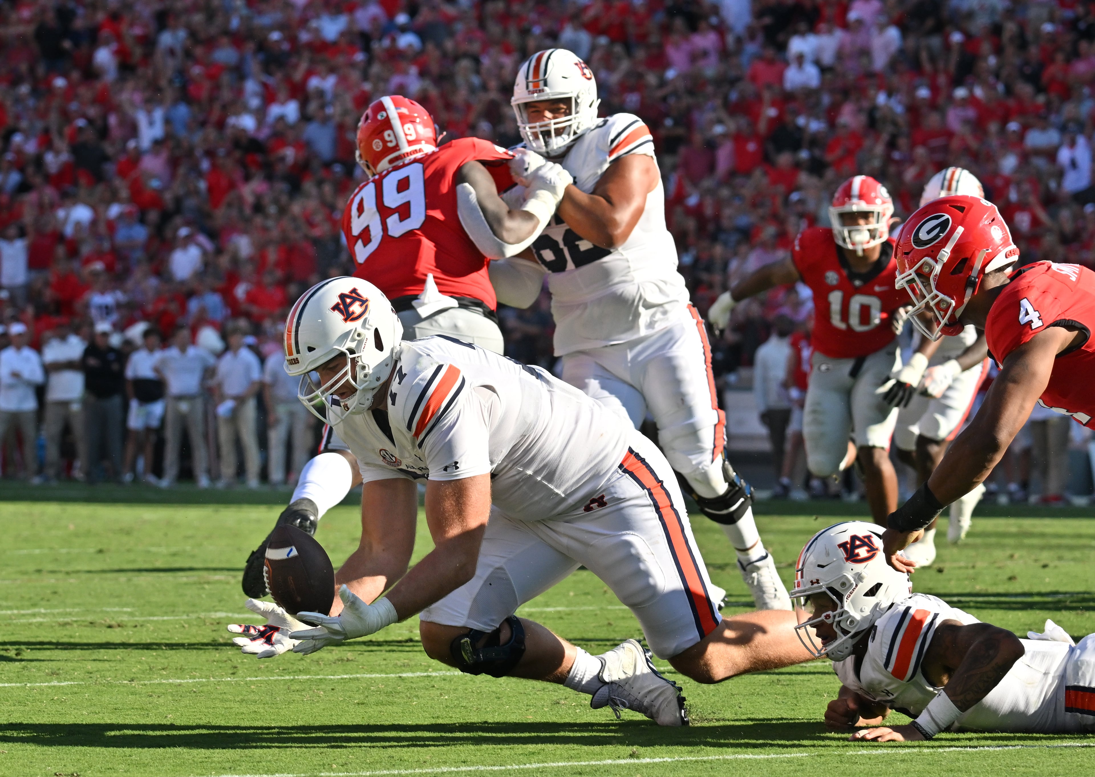 Auburn's offensive lineman Kilian Zierer (77) recovers the fumble by Auburn's quarterback Robby Ashford (9) during the first half in a NCAA college football game at Sanford Stadium in Athens on Saturday, October 8, 2022. (Hyosub Shin / Hyosub.Shin@ajc.com)
