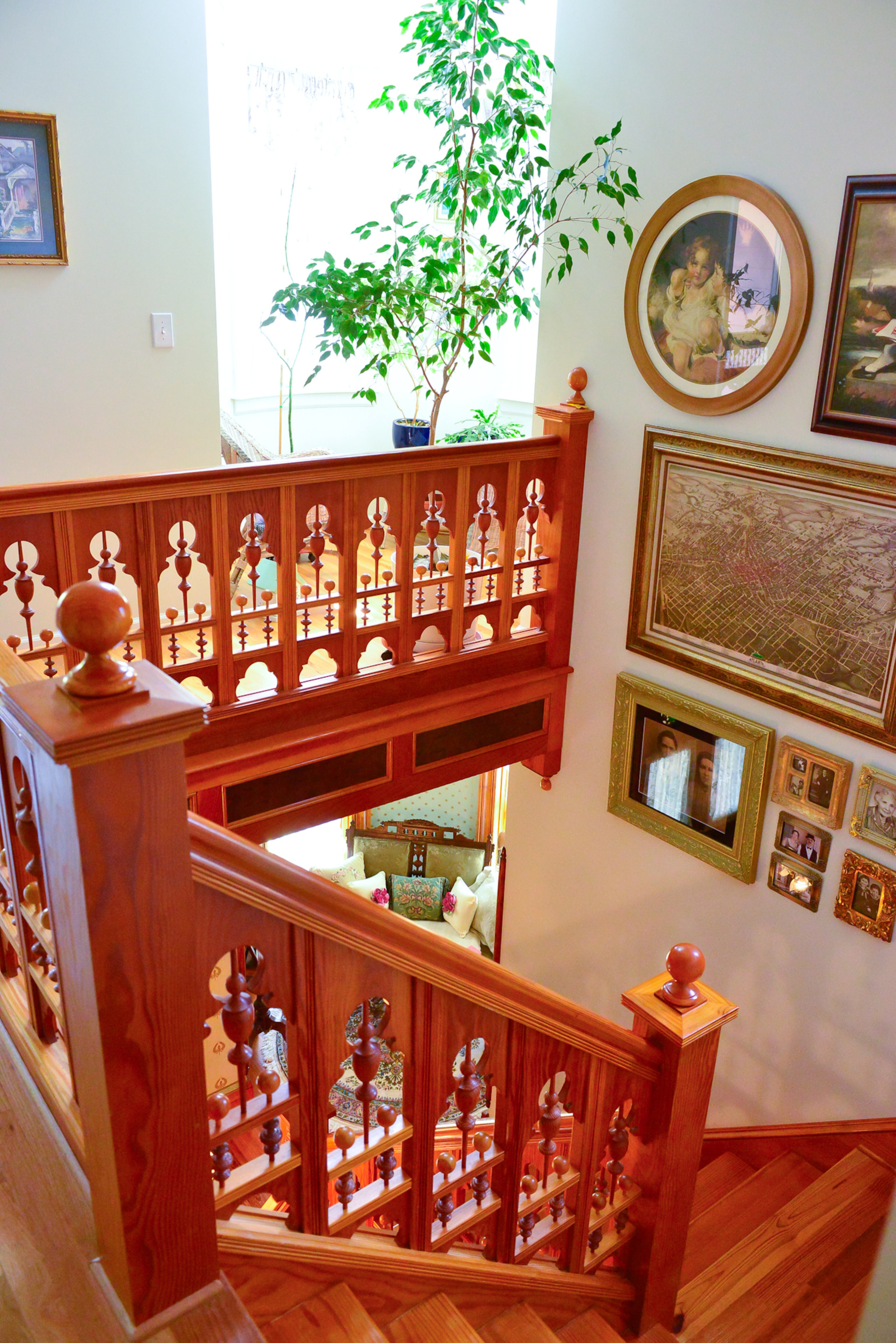 The intricate staircase showcases the work of homeowner Mike Dufano, an electrical engineer, who cut many of the pieces before the home was built. In the stairwell, there's a map with a birds' eye view of Atlanta from the 1890s, family photos and pictures of the Dufanos in period costumes.