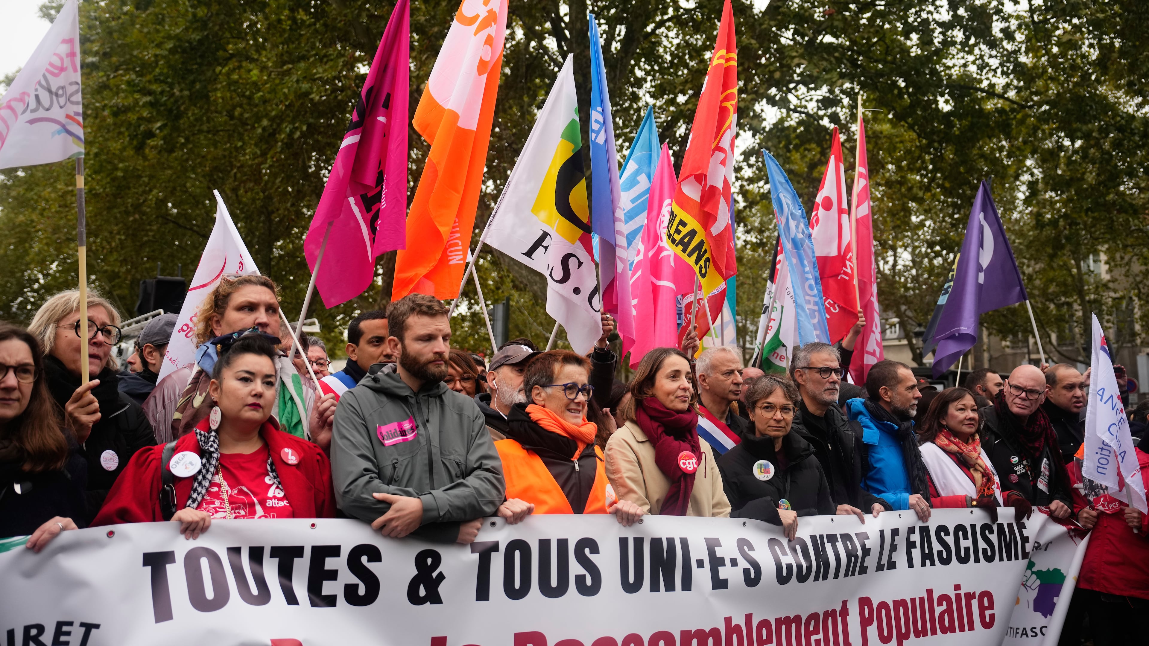 Leftists unions and political parties members hold a banner reading "all united against fascism. For the popular rally and social progress" during a protest on the sidelines of the far-right party Rassemblement National (RN) congress, in Orleans, France, Saturday, Oct. 24, 2026. (AP Photo/Teresa Suarez)