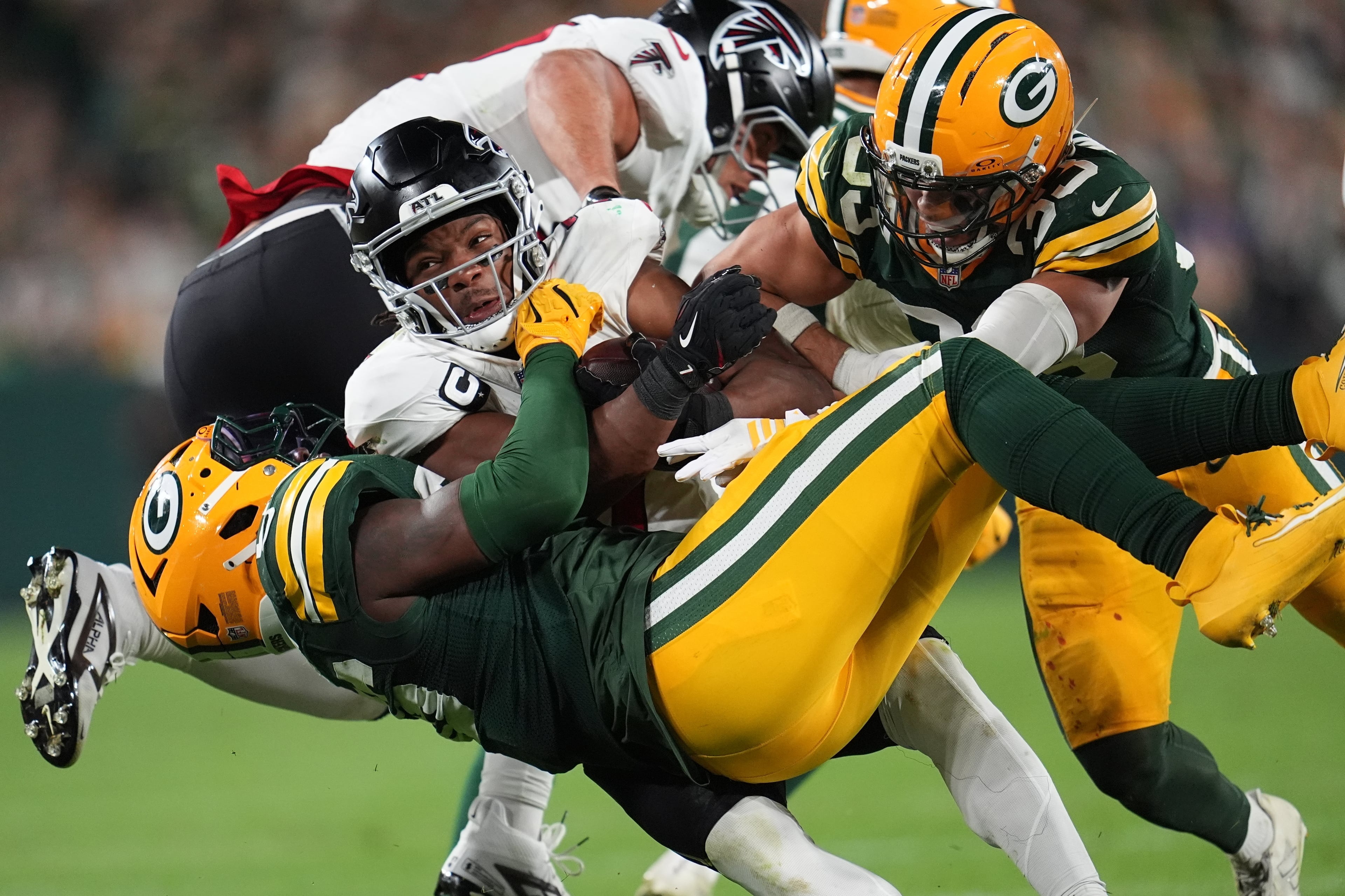 Packers linebacker Edgerrin Cooper (left) and safety Evan Williams (right) stop Falcons running back Bijan Robinson during the second half of their game on Thursday, Sept. 24, 2026, in Green Bay, Wis. (Abbie Parr/AP)