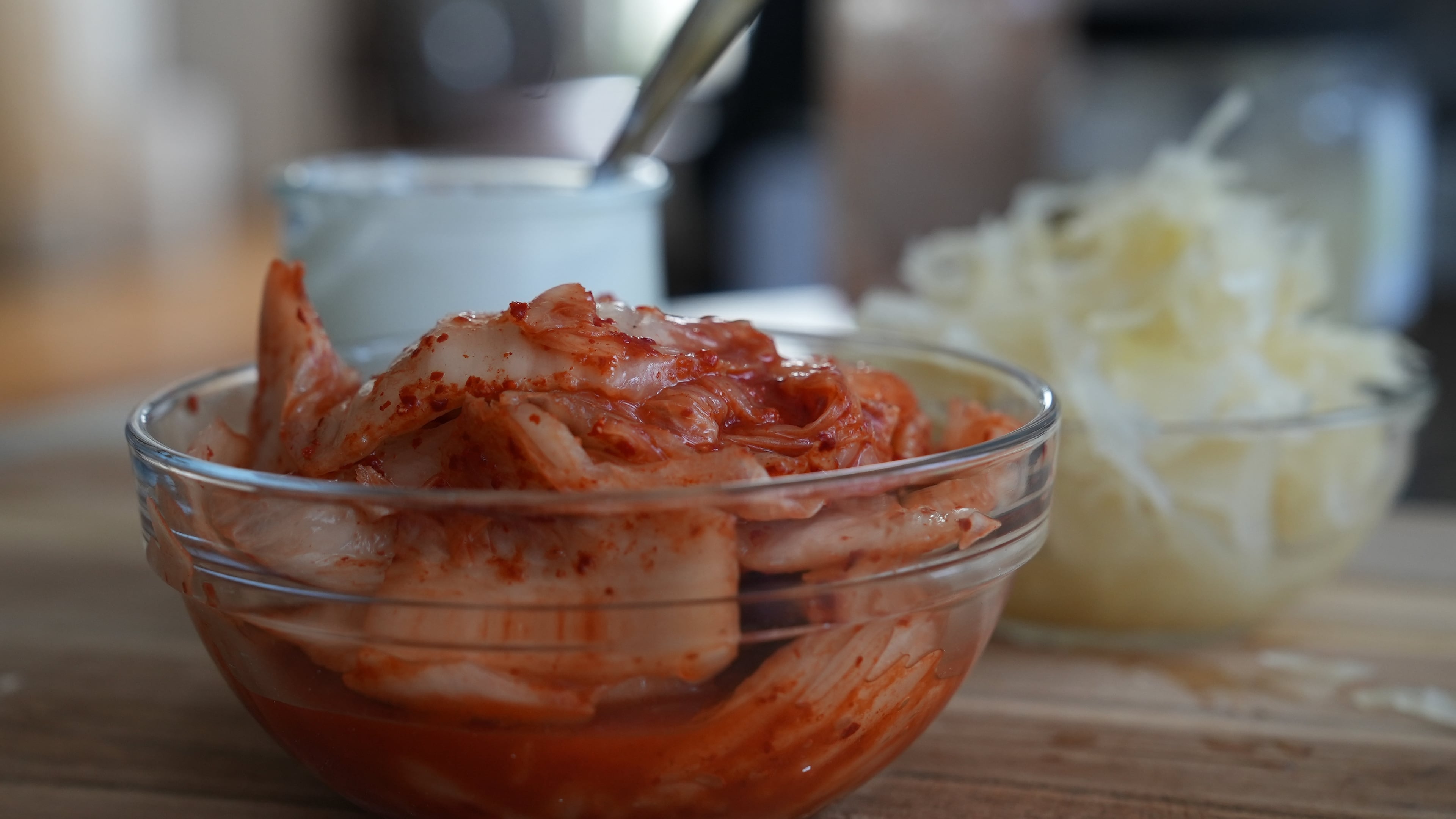 Kimchi, sauerkraut and yogurt are displayed on a kitchen table in New York on July 10, 2026. (AP Photo/Mary Conlon)