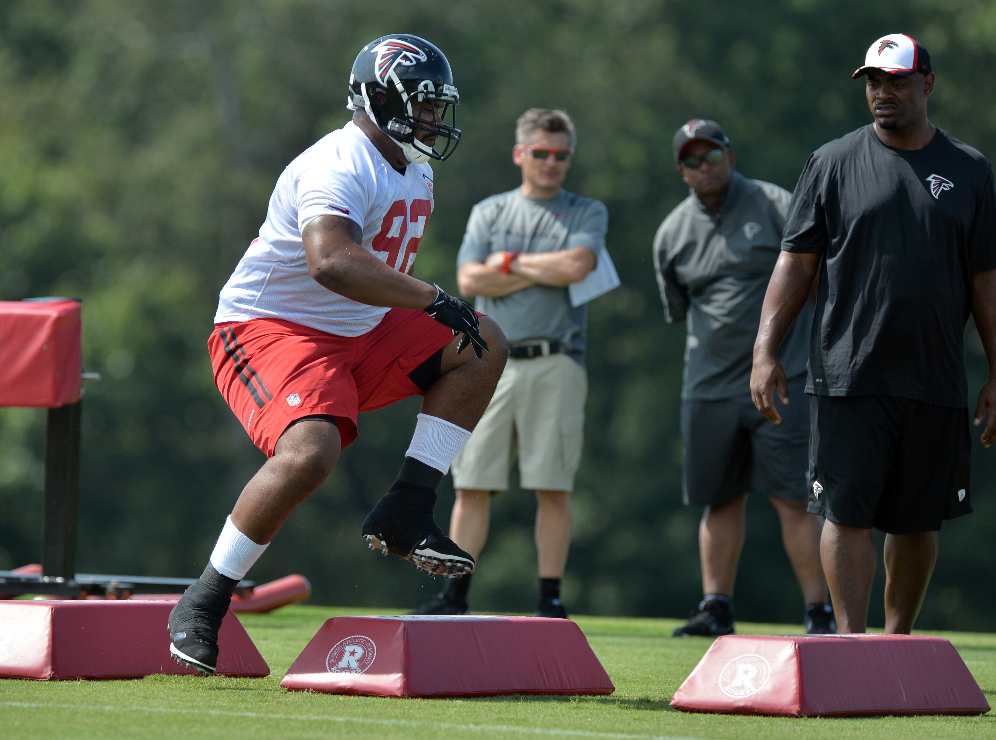 Atlanta Falcons Travian Robertson participates in a drill front of GM Thomas Dimitroff on Friday, July 25, 2014.