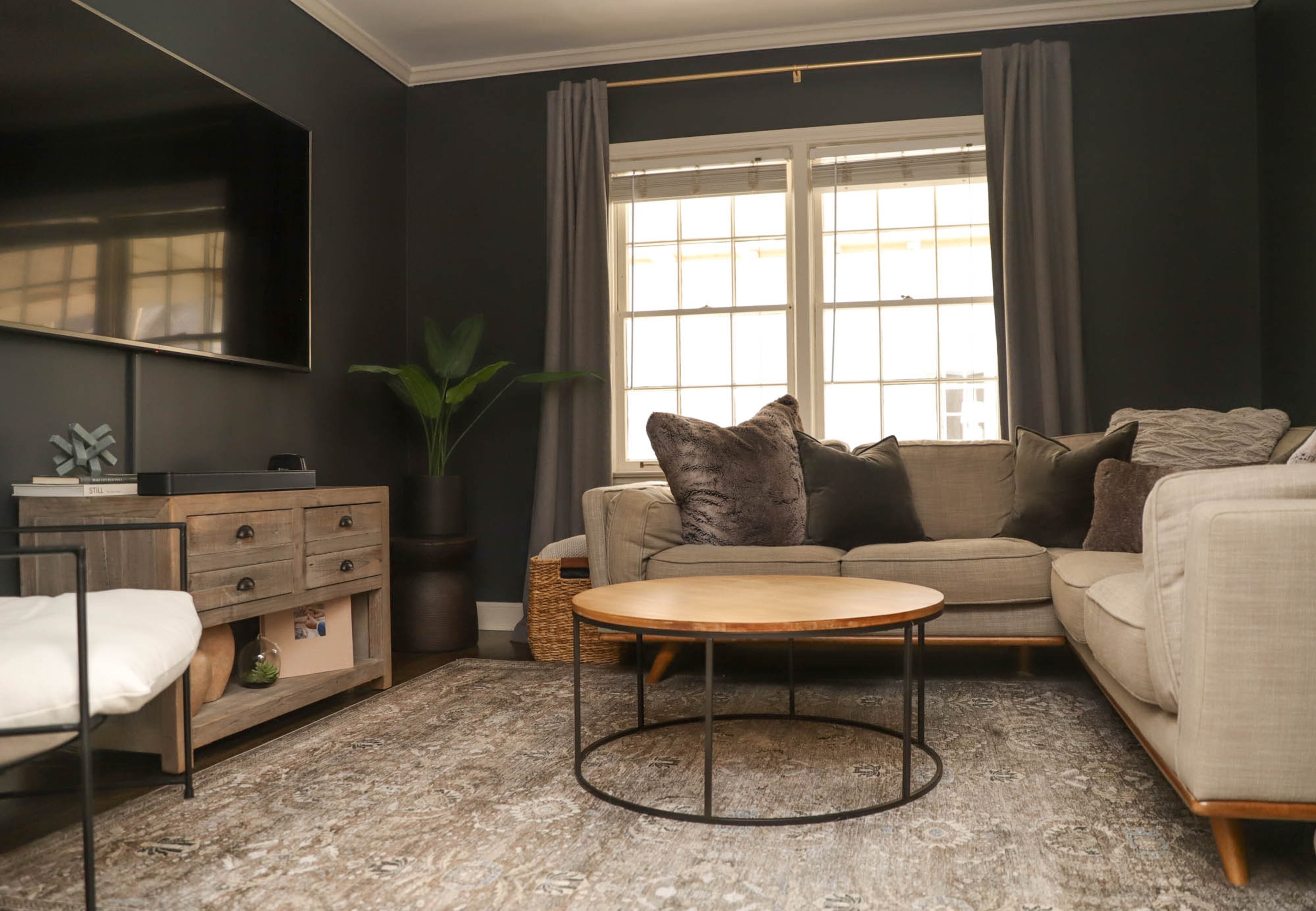 Painting the TV room this deep inky shade of French Duvet by Sherwin Williams was a risky move, but one the couple felt comfortable making since they had already glimpsed it in person. “The inspiration was that my dad recently renovated a cute home in Southern California which has super high ceilings and was painted the same dark navy color. I’m really excited about how it turned out,” Kerry Phillips says. The couple also removed the existing doors that closed off the space to create a sense of flow, and padded out the space with furniture they had already collected over the years, like the Article couch, Rejuvenation Hardware credenza, and the West Elm coffee table. Text by Lori Keong/Photo by Reynolds Rogers