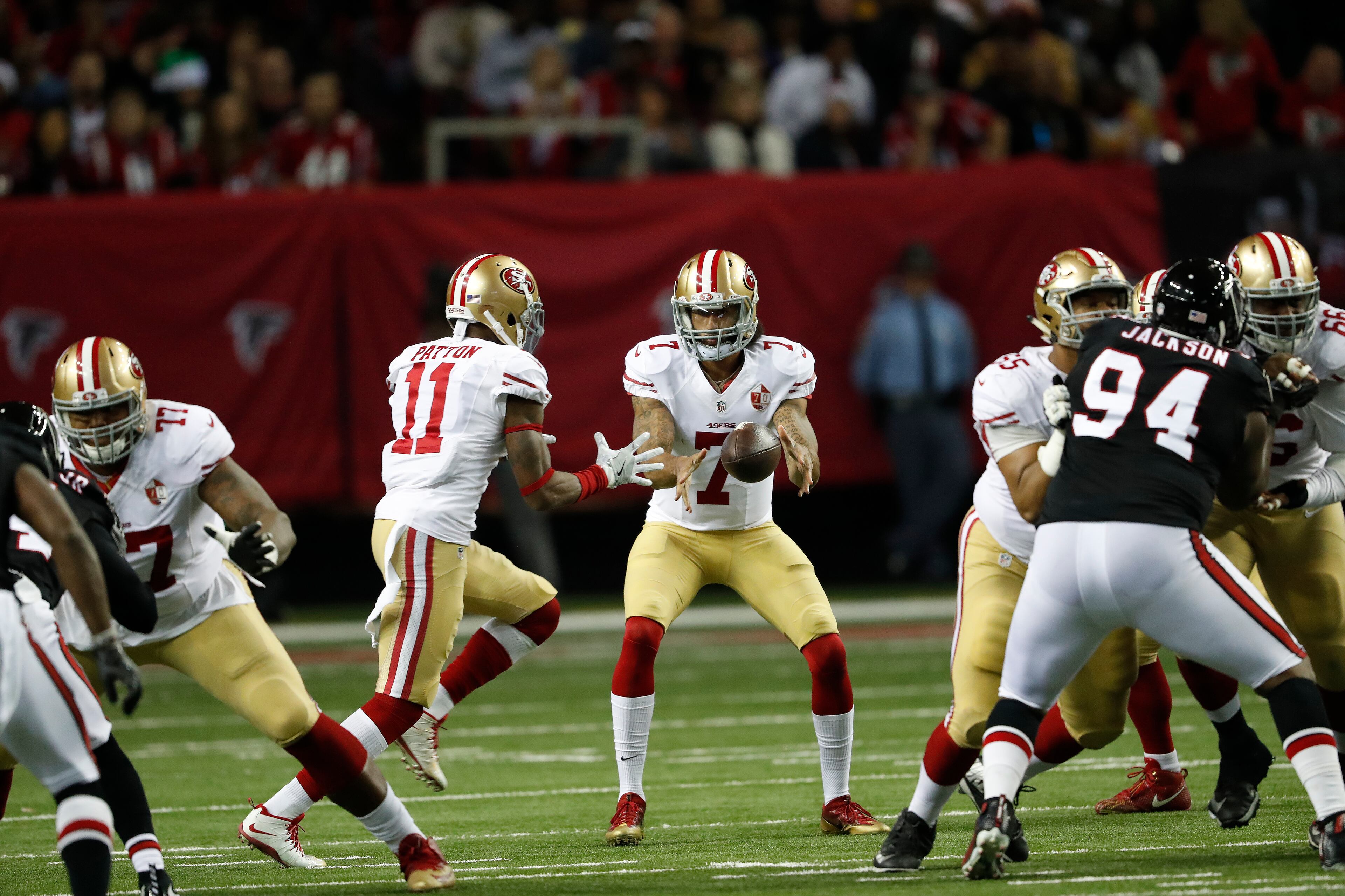 San Francisco 49ers quarterback Colin Kaepernick (7) prepares to hand off the ball to San Francisco 49ers wide receiver Quinton Patton (11) against the Atlanta Falcons during the first half of an NFL football game, Sunday, Dec. 18, 2016, in Atlanta. (AP Photo/John Bazemore)