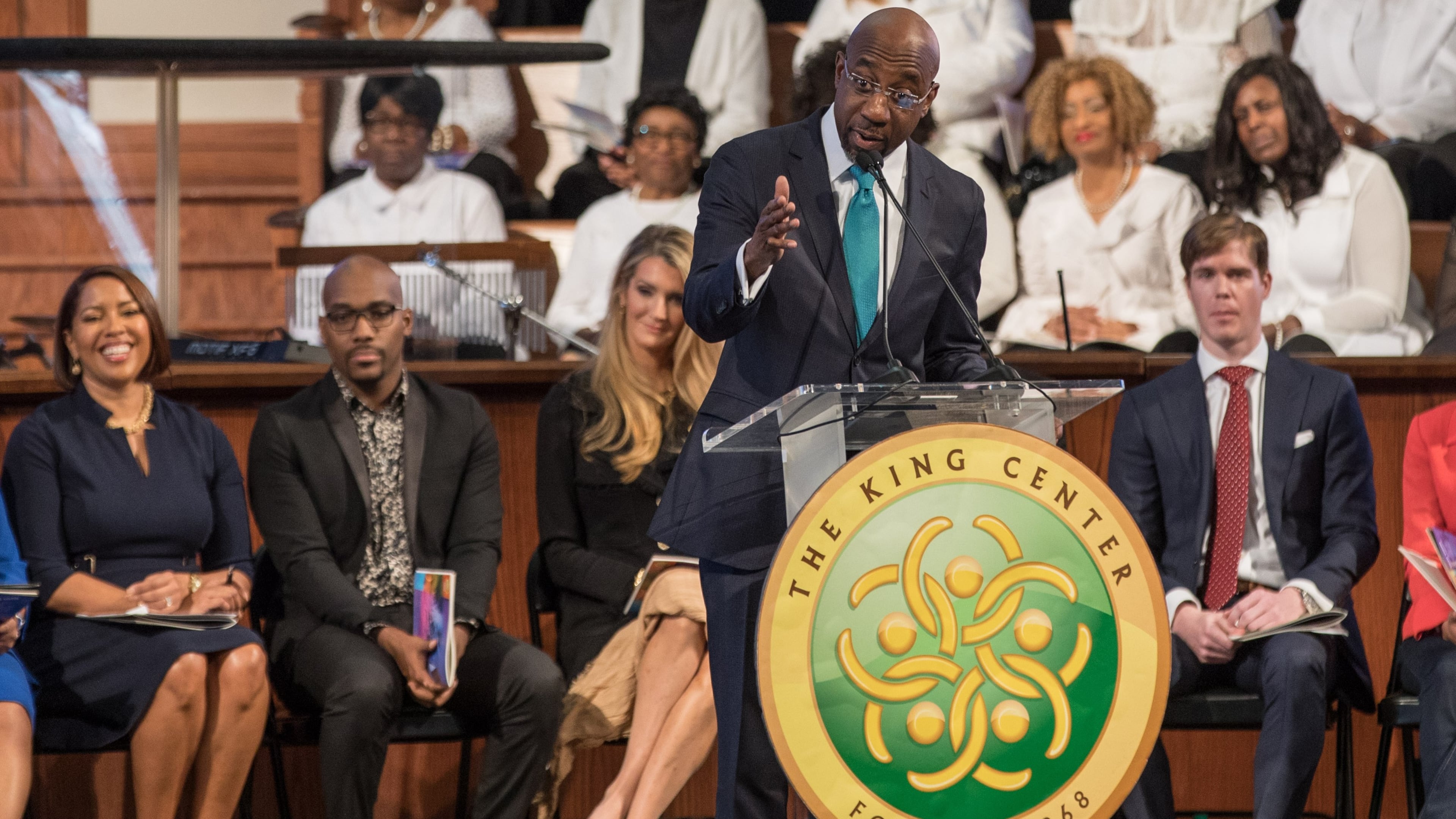 With U.S. Sen. Kelly Loeffler in the background, the Rev. Raphael G. Warnock speaks during the Martin Luther King, Jr. annual commemorative service at Ebenezer Baptist Church in Atlanta on Monday, Jan. 20, 2020. BRANDEN CAMP/SPECIAL