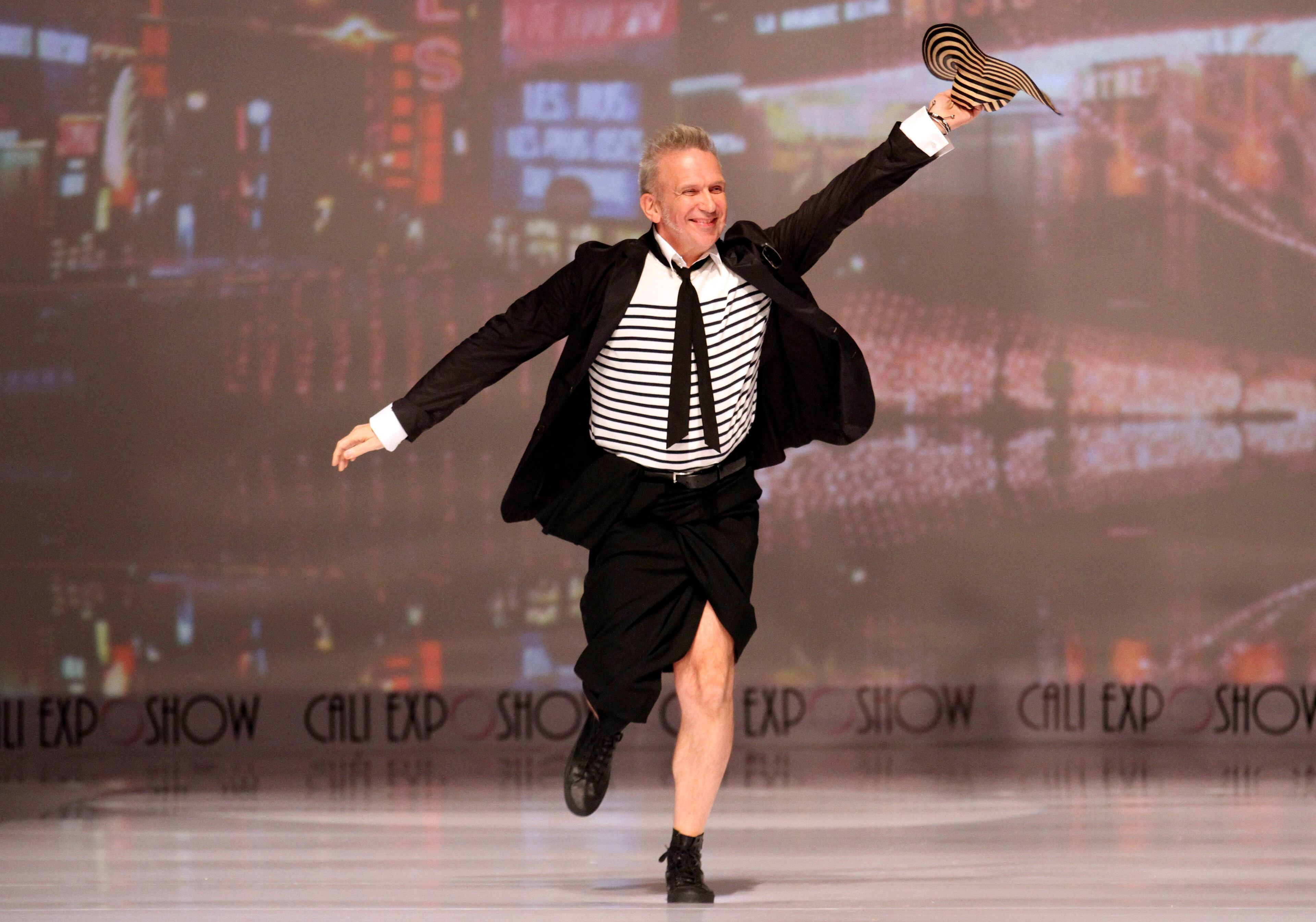 French designer Jean Paul Gaultier waves a Colombian hat from the catwalk during the Cali Exposhow fashion week in Cali, Colombia, Wednesday, Oct. 17, 2012.