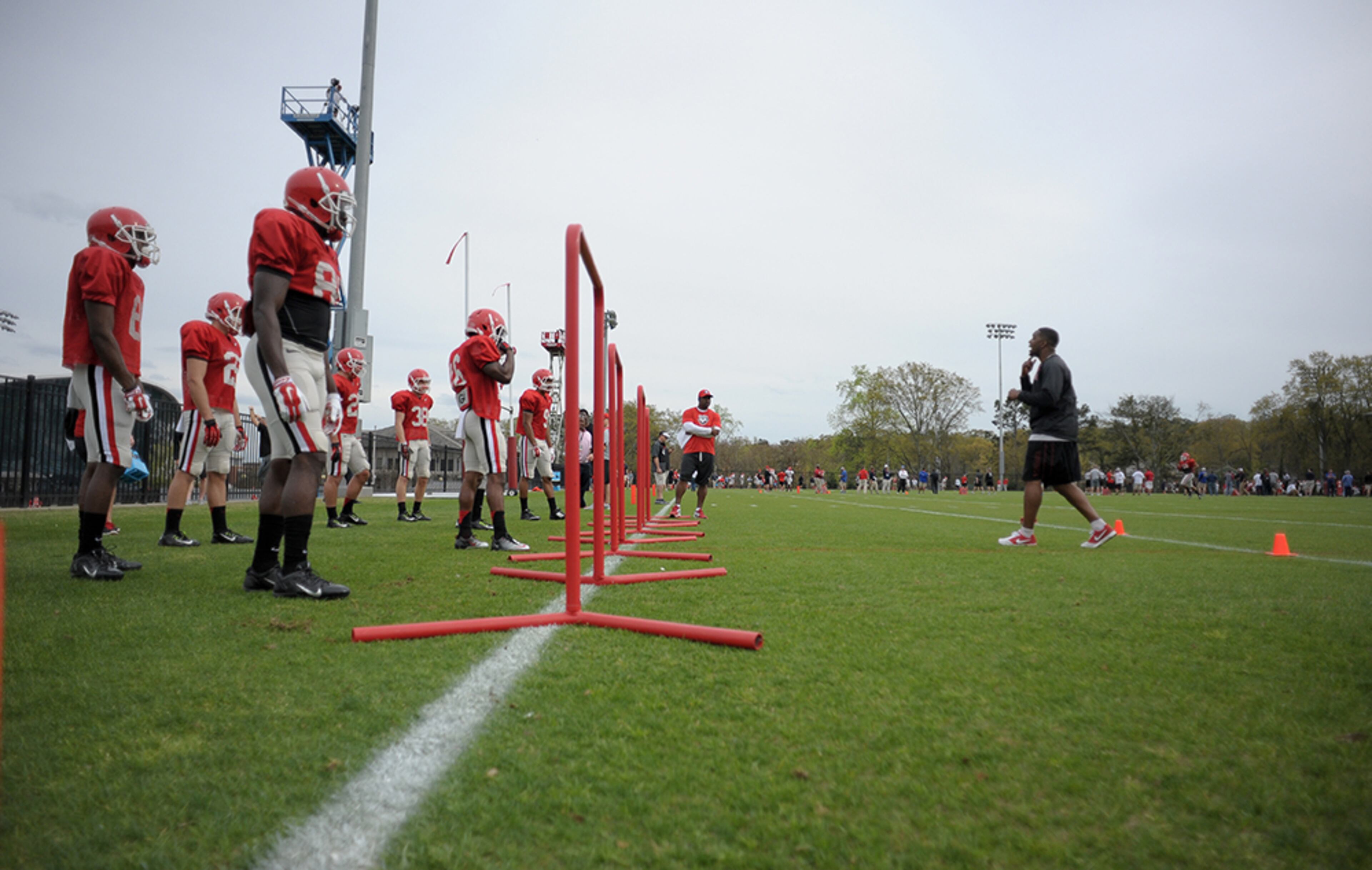 Wide receivers coach Bryan McClendon speaks with Georgia players during a spring football practice session on Thursday, March 26, 2015, in Athens. The Bulldogs will hold 15 practices this spring ahead of the G-Day spring game April 11.