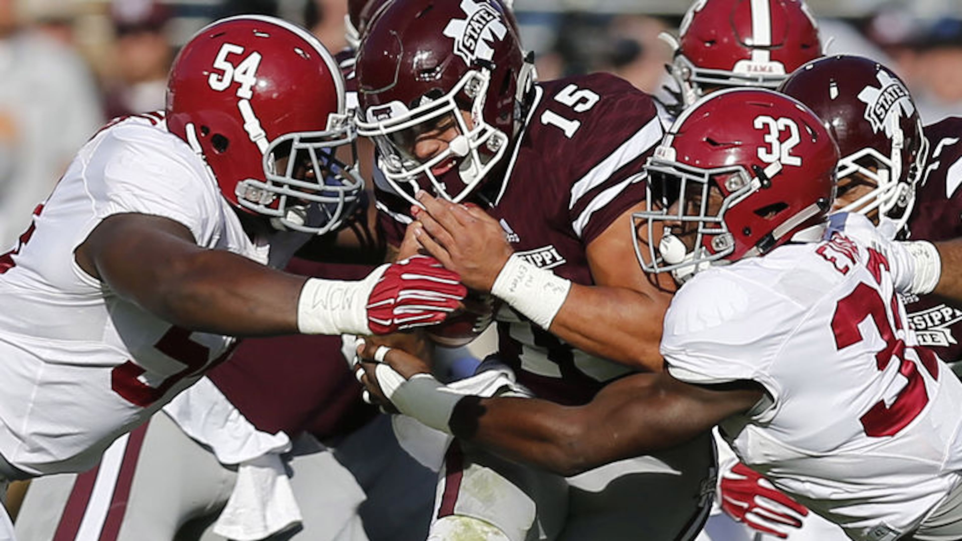 Mississippi State quarterback Dak Presscott (15) being tackled by Alabama's Dalvin Tomlinson (54) and linebacker Rashaan Evans (32) in a Nov. 2015 game. (Rogelio V. Solis/Associated Press)