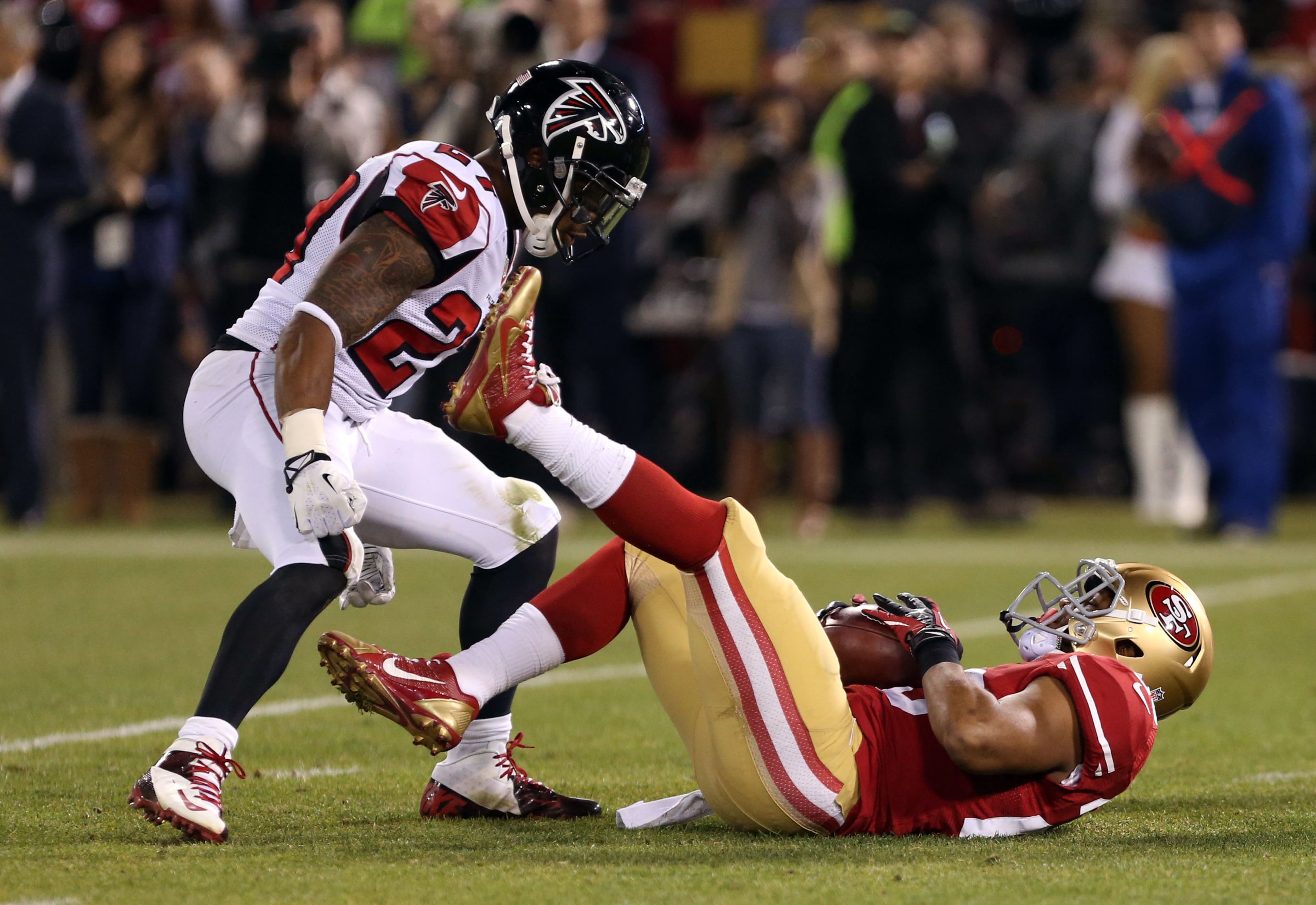Dec 23, 2013; San Francisco, CA, USA; San Francisco 49ers running back LaMichael James (23) catches the punt against Atlanta Falcons cornerback Robert McClain (27) during the second quarter of the final regular season game at Candlestick Park. Mandatory Credit: Kelley L Cox-USA TODAY Sports