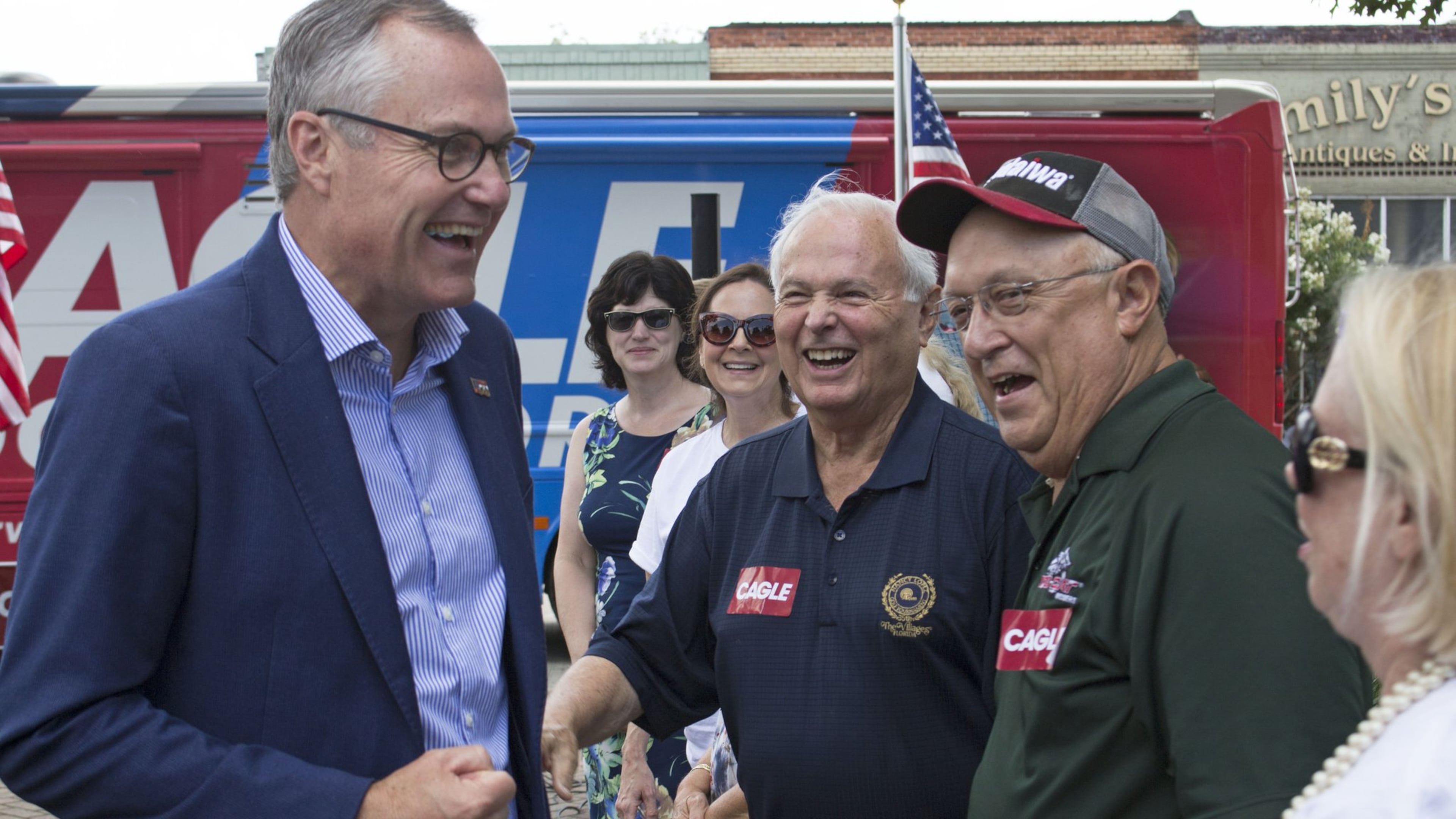Lt. Gov. Casey Cagle, left, greets J.T. Williams, Warren Holder and Vikki Consiglio, left to right, Thursday in McDonough Square during one of Cagle’s bus tour stops for his campaign for Georgia governor. Jenna Eason / Jenna.Eason@coxinc.com