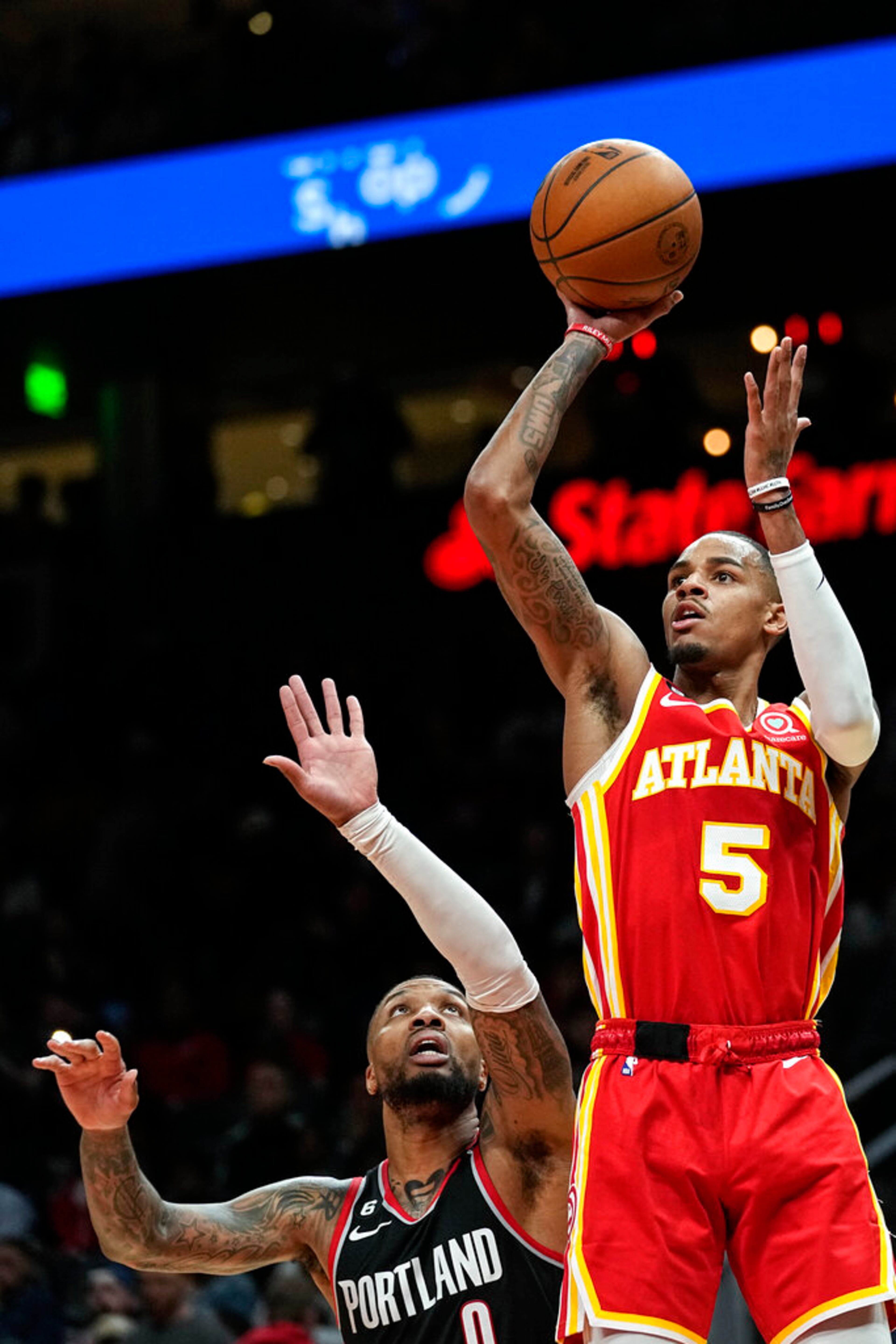 Atlanta Hawks guard Dejounte Murray (5) shoots as Portland Trail Blazers guard Damian Lillard (0) defends during the first half of an NBA basketball game Friday, March 3, 2023, in Atlanta. (AP Photo/John Bazemore)
