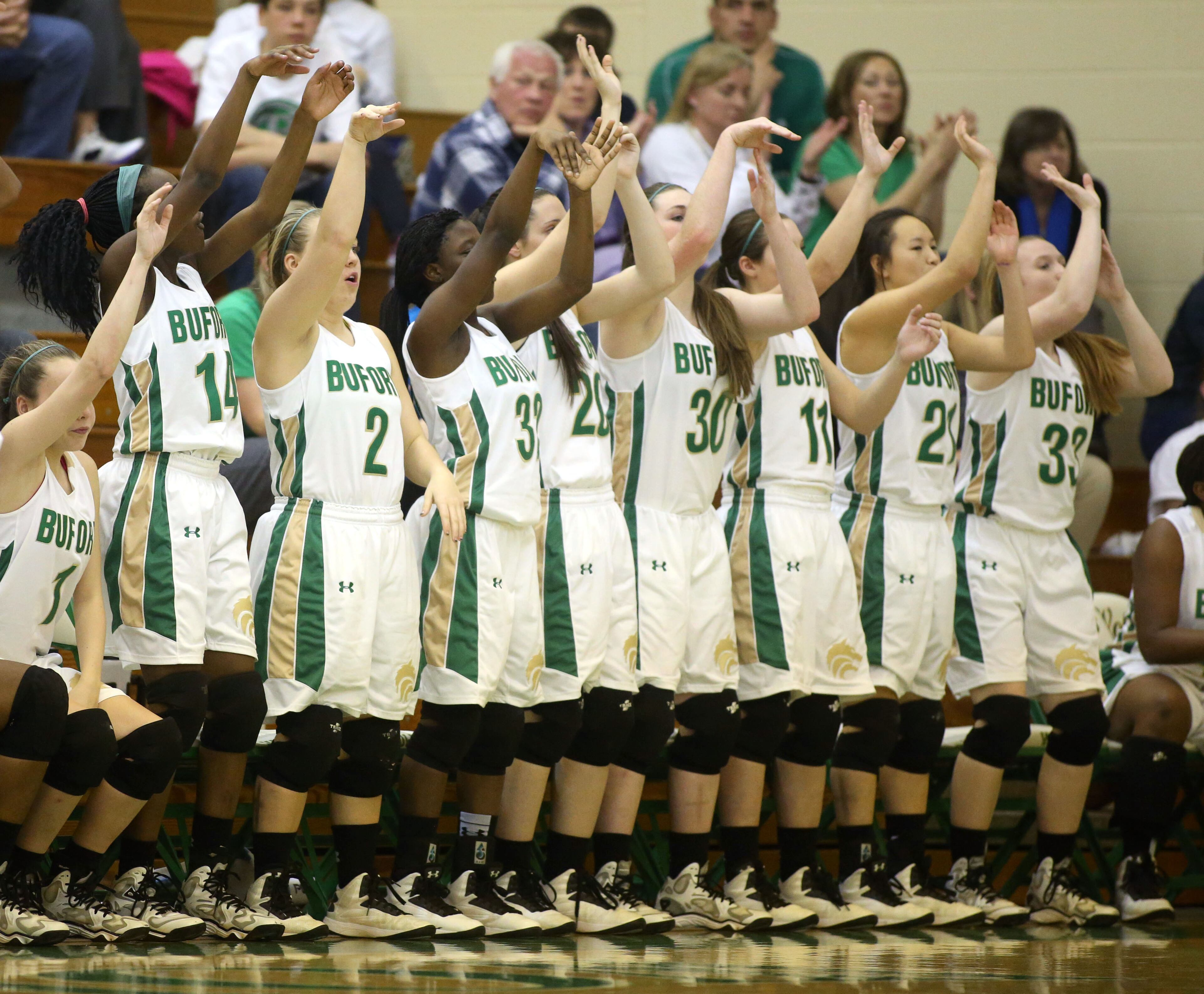 The Buford bench follows through on a free throw as it mimics a teammate after free throw attempts during their win over Decatur Monday night in Buford, Feb. 24, 2014. Buford defeated Decatur 41-28 in the second round of the Class AAA state basketball tournament. JASON GETZ / SPECIAL