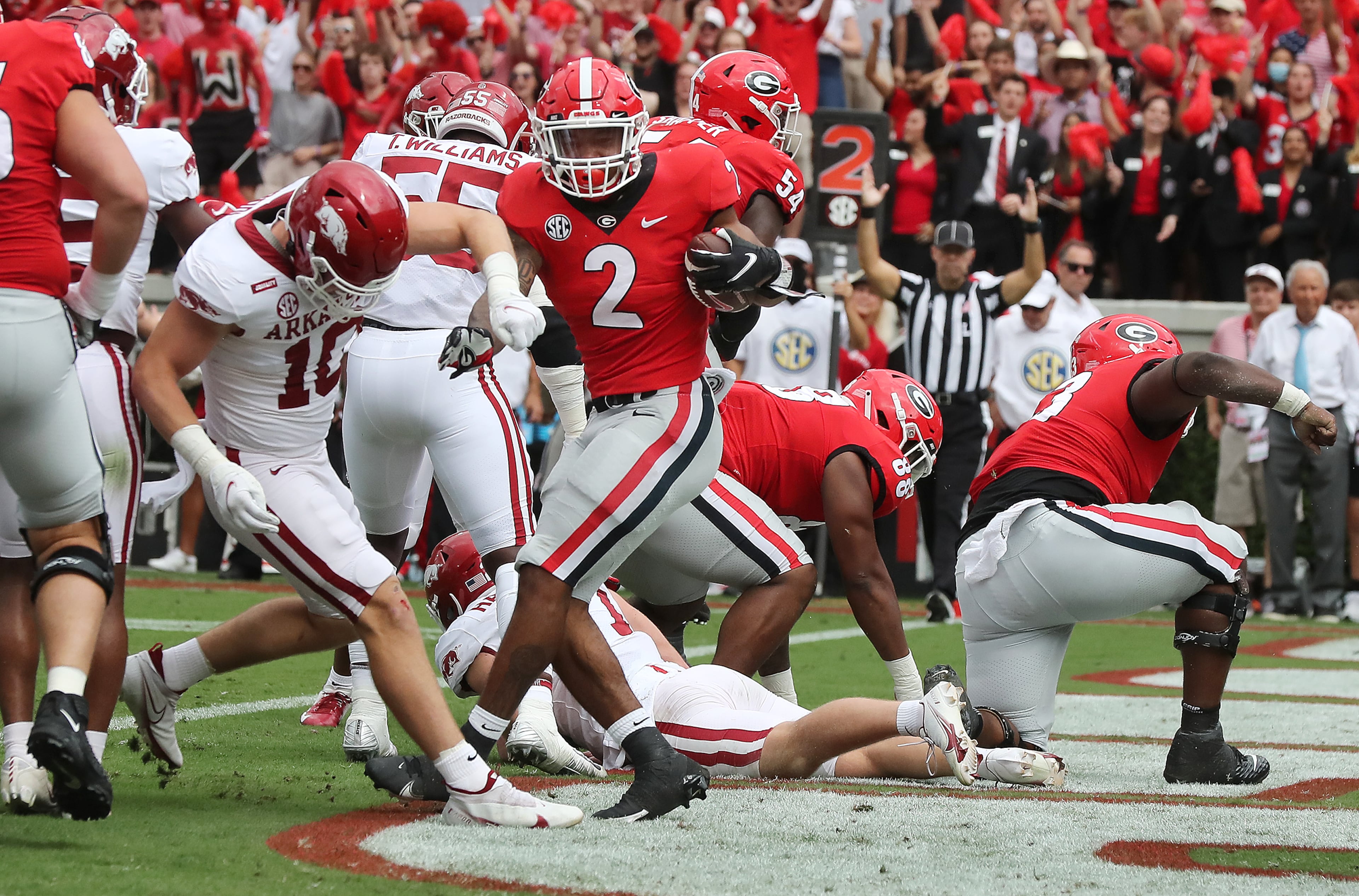 100221 ATHENS: Georgia running back Kendall Milton backs his way into the endzone against Arkansas following a strong push by the offensive line to take a 14-0 lead during the first quarter in a NCAA college football game on Saturday, Oct. 2, 2021, in Athens. “Curtis Compton / Curtis.Compton@ajc.com”