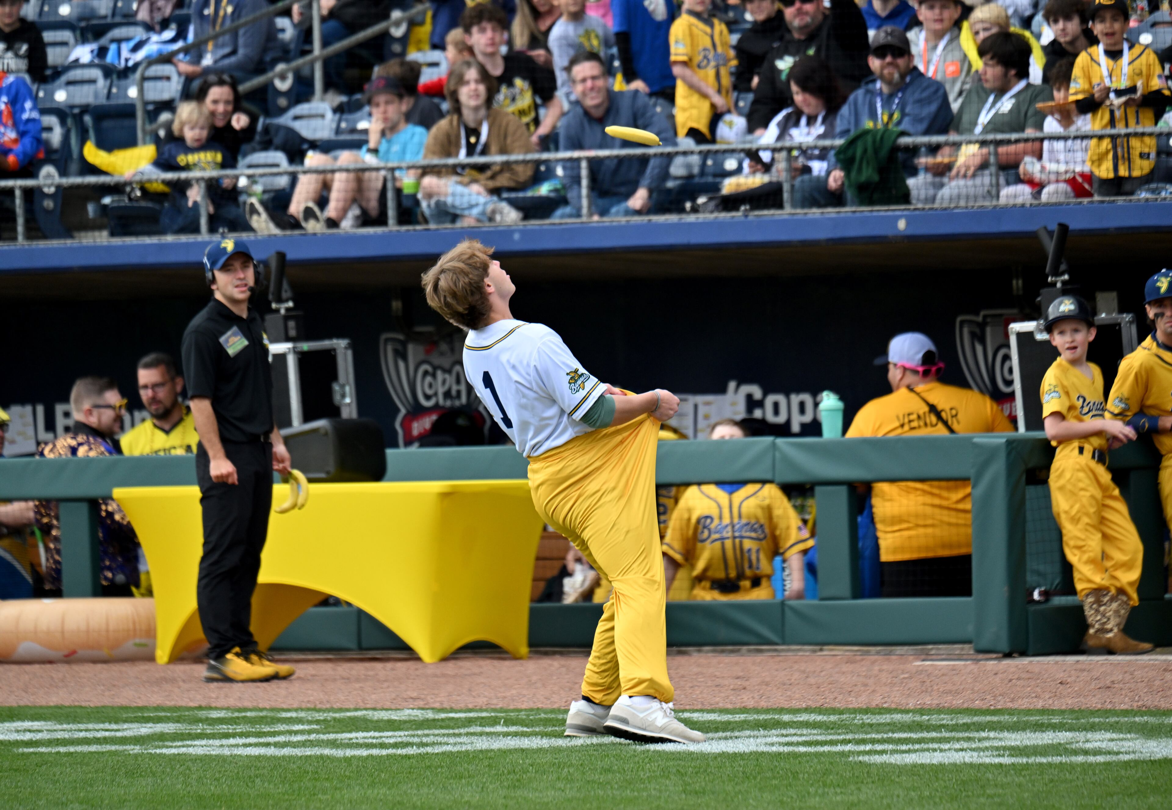 A fan catches a banana with his pants during pregame fun. (Hyosub Shin / Hyosub.Shin@ajc.com)