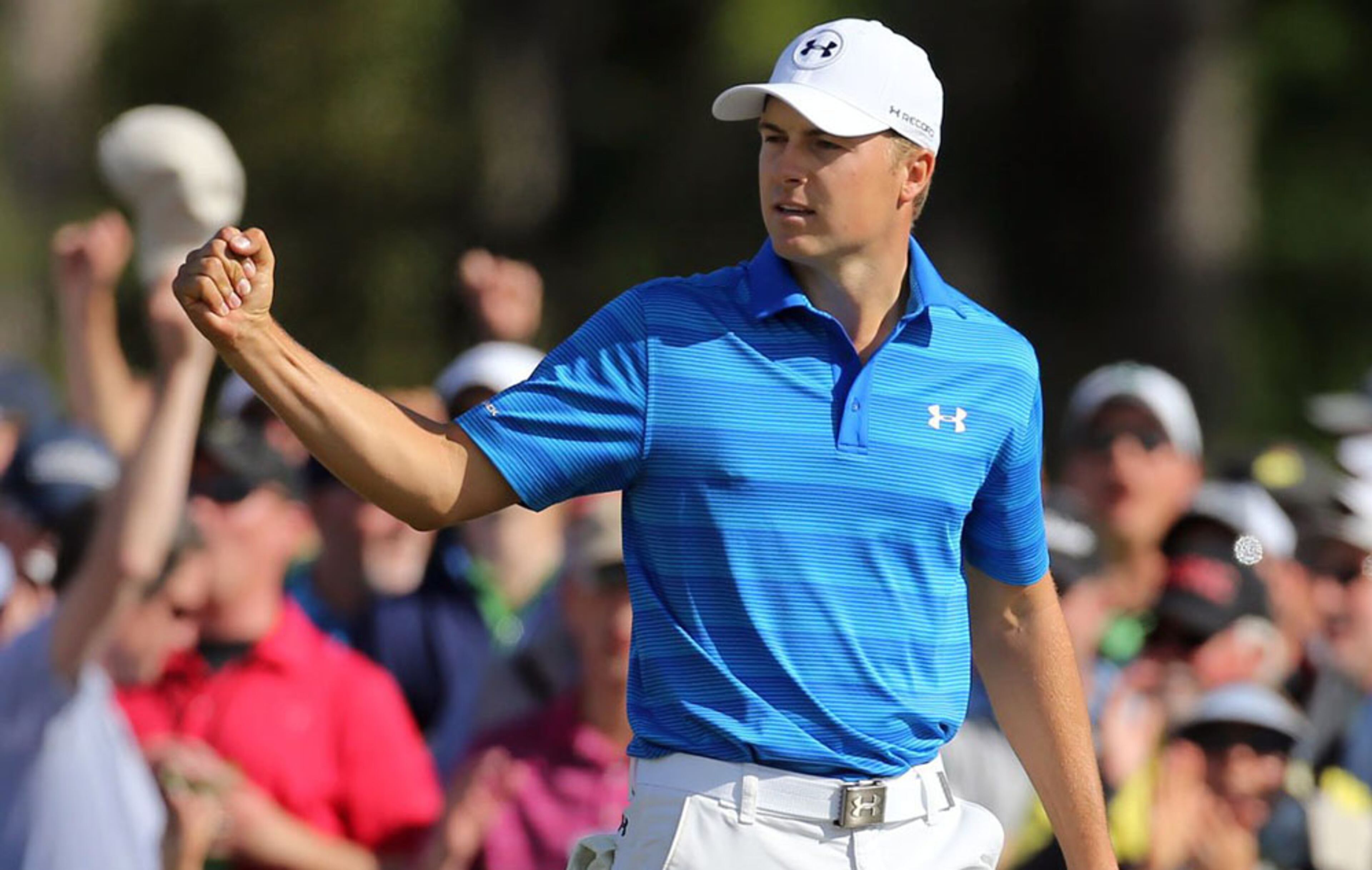 Jordan Spieth reacts to a birdie putt on the 9th green to go to 7-under during the final round of the 80th Masters at the Augusta National Golf Club, Sunday, April 10, 2016.