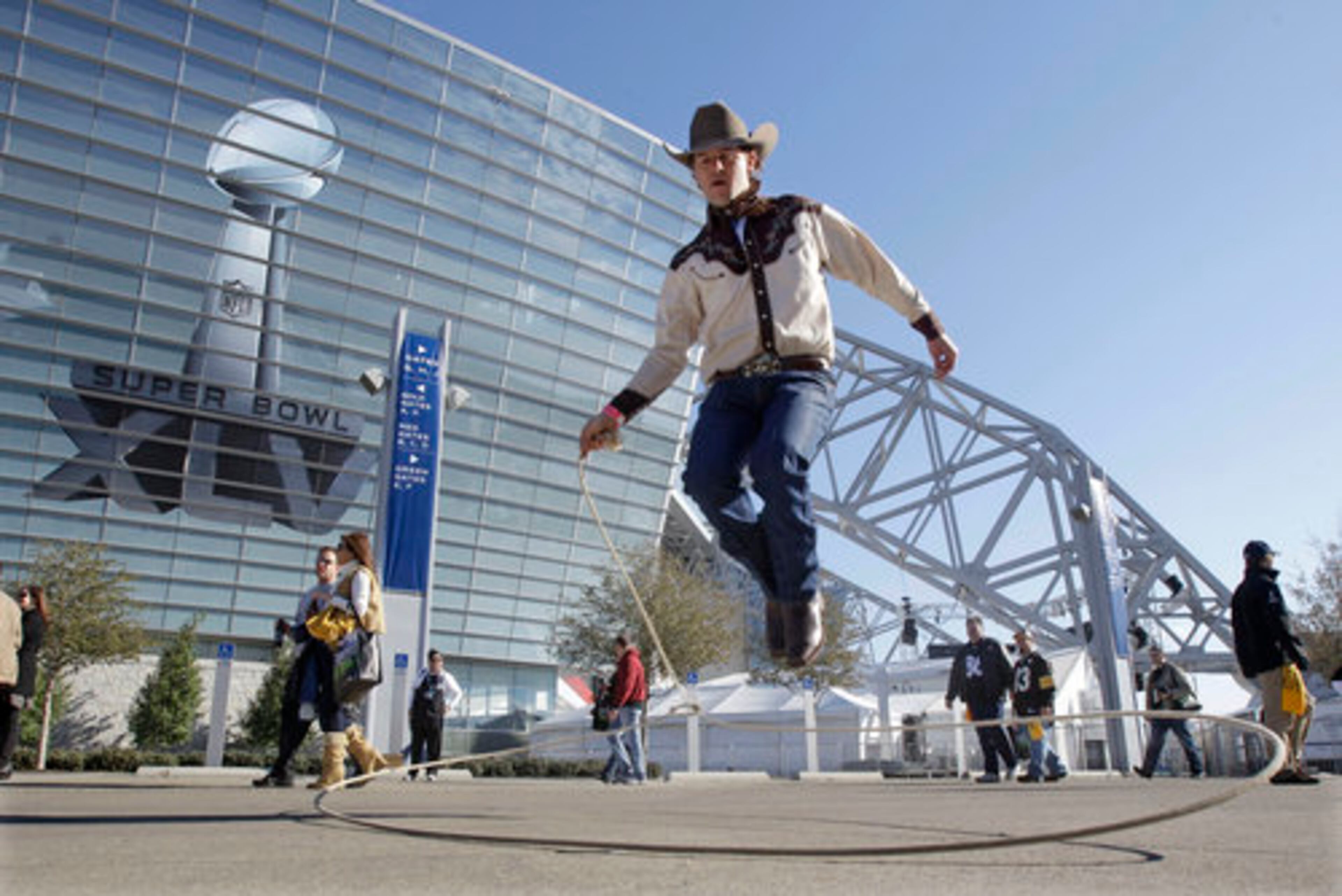 Joe Baker of Weatherford, Texas, plays with a lasso outside Cowboys Stadium before the NFL football Super Bowl XLV game between the Green Bay Packers and the Pittsburgh Steelers Sunday, Feb. 6, 2011, in Arlington, Texas.