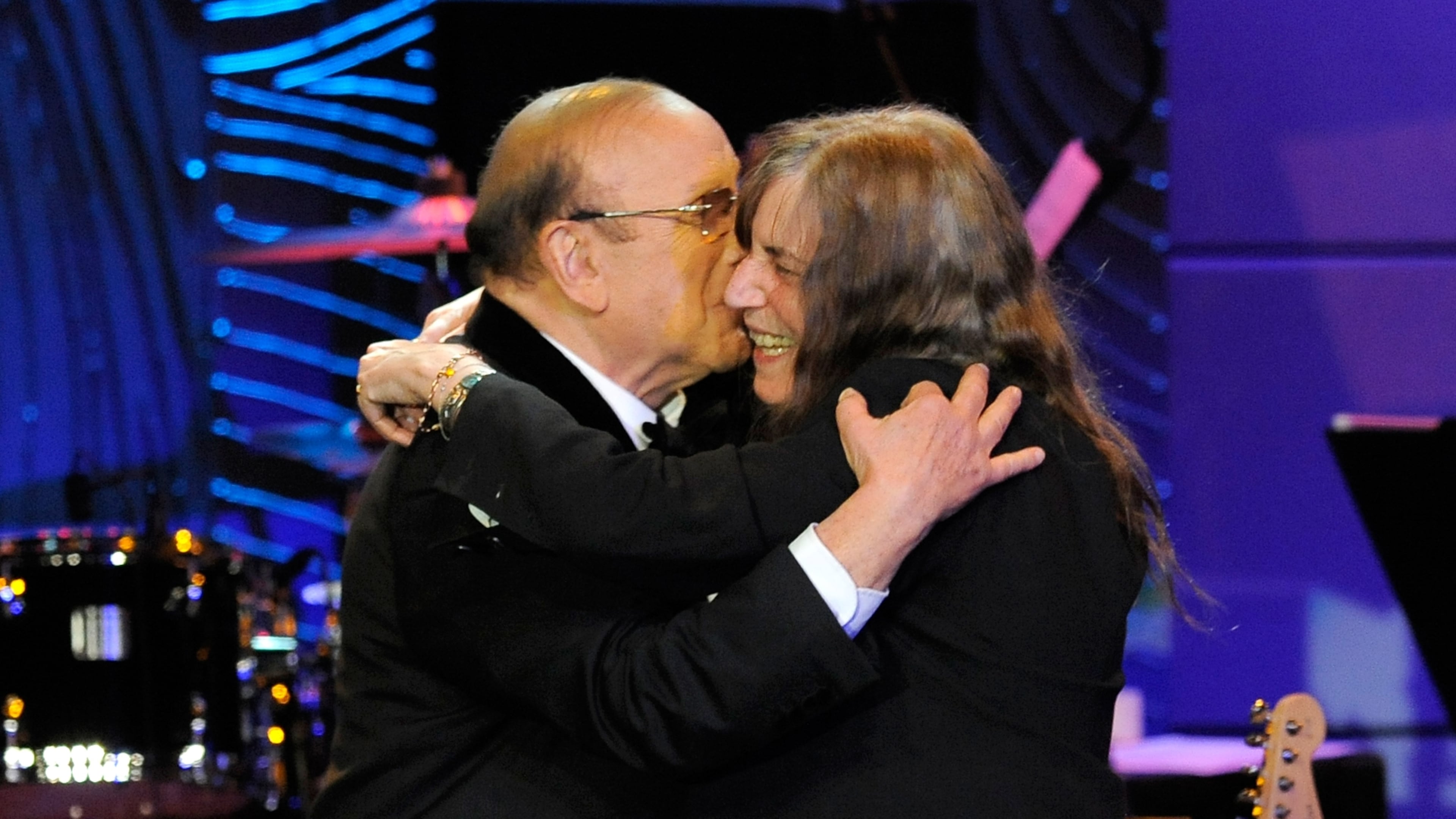 FILE - Music producer Clive Davis, left, and recording artist Patti Smith embrace onstage at the Clive Davis Pre-Grammy Gala in Beverly Hills, Calif., on Feb. 9, 2013. (Photo by Chris Pizzello/Invision/AP, File)