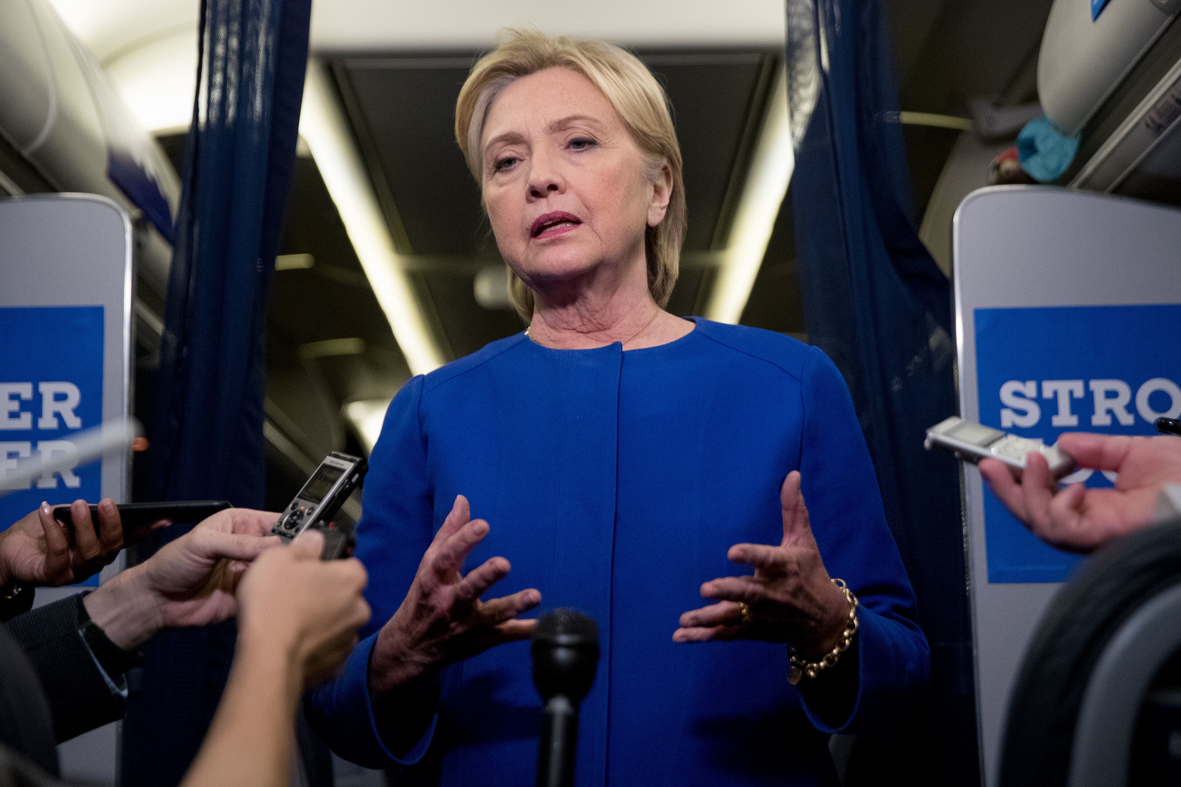 Democratic presidential candidate Hillary Clinton gives remarks on the explosion in Manhattan's Chelsea neighborhood onboard her campaign plane at Westchester County Airport, in White Plains, N.Y., Saturday, Sept. 17, 2016. (AP Photo/Andrew Harnik)