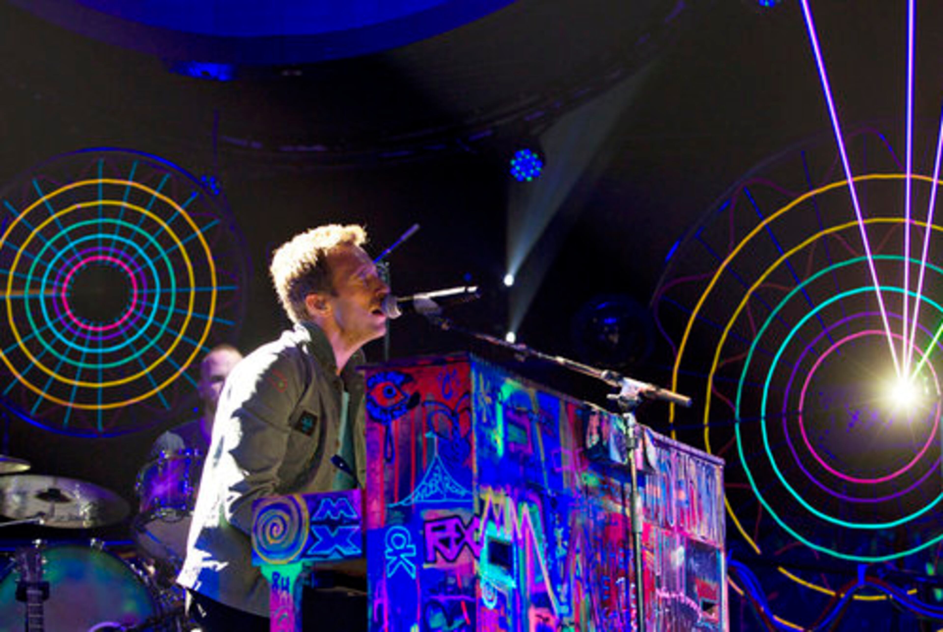 Chris Martin leads Coldplay from his day-glo graffitied piano Tuesday as the British pop-rock act kicked off the North American leg of its tour in support of "Mylo Xyloto" at the Rexall Place in Edmonton, Alberta, Canada.