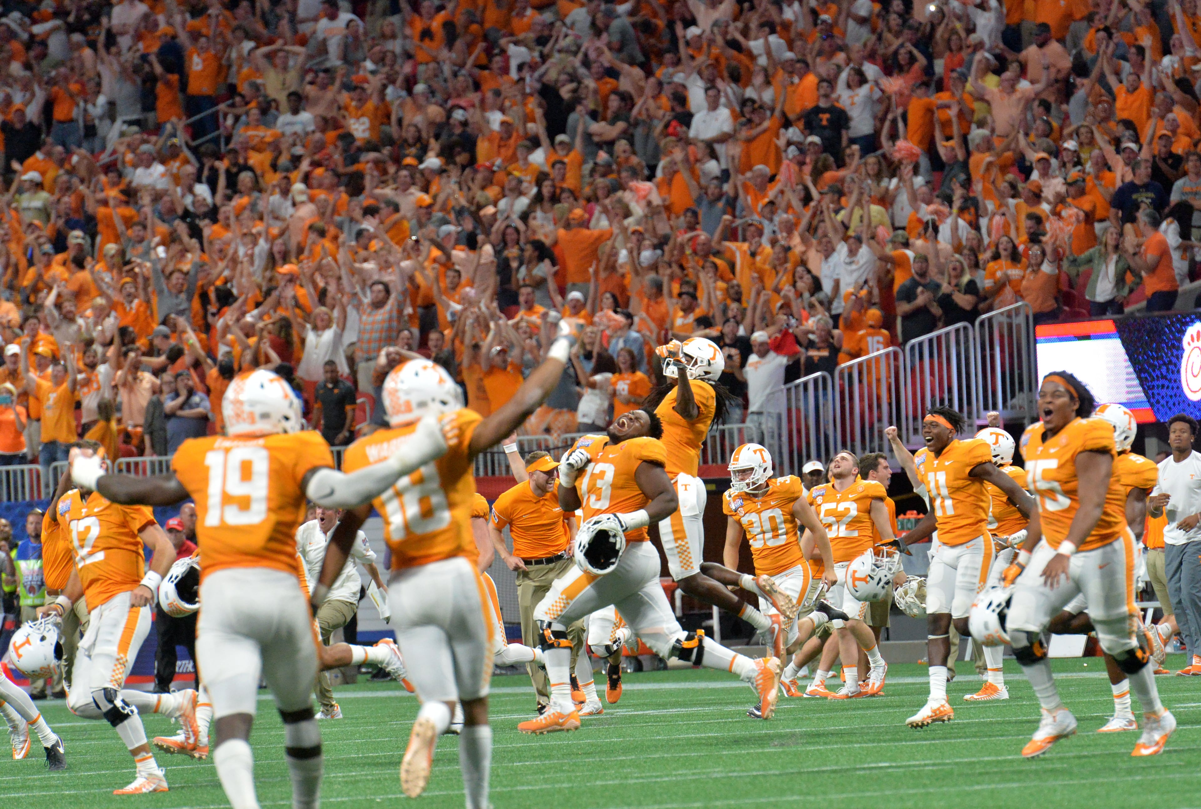 Tennessee players celebrate their 42-41 double overtime win over Georgia Tech Monday at the Mercedes-Benz Stadium. HYOSUB SHIN / HSHIN@AJC.COM