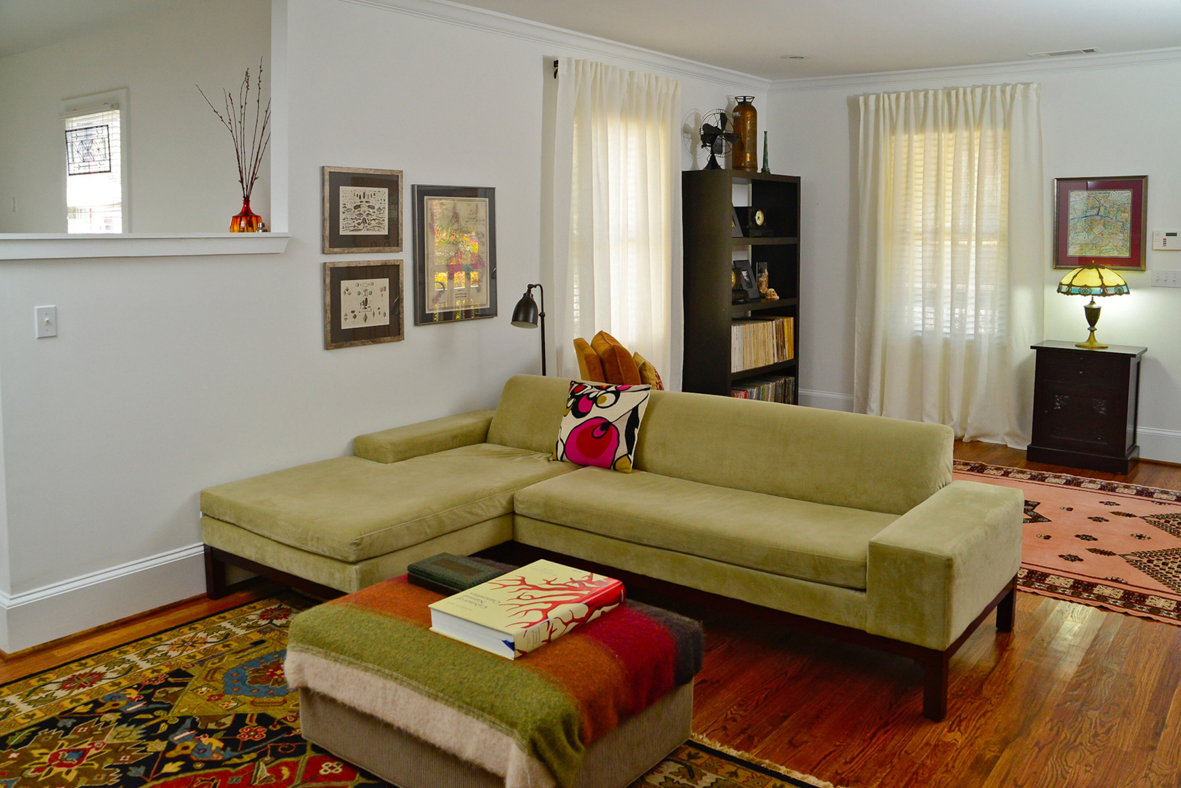 The living room sectional sofa is from West Elm and the Persian rug is from World of Rugs and contrast the walls, which are painted Pure White by Benjamin Moore.