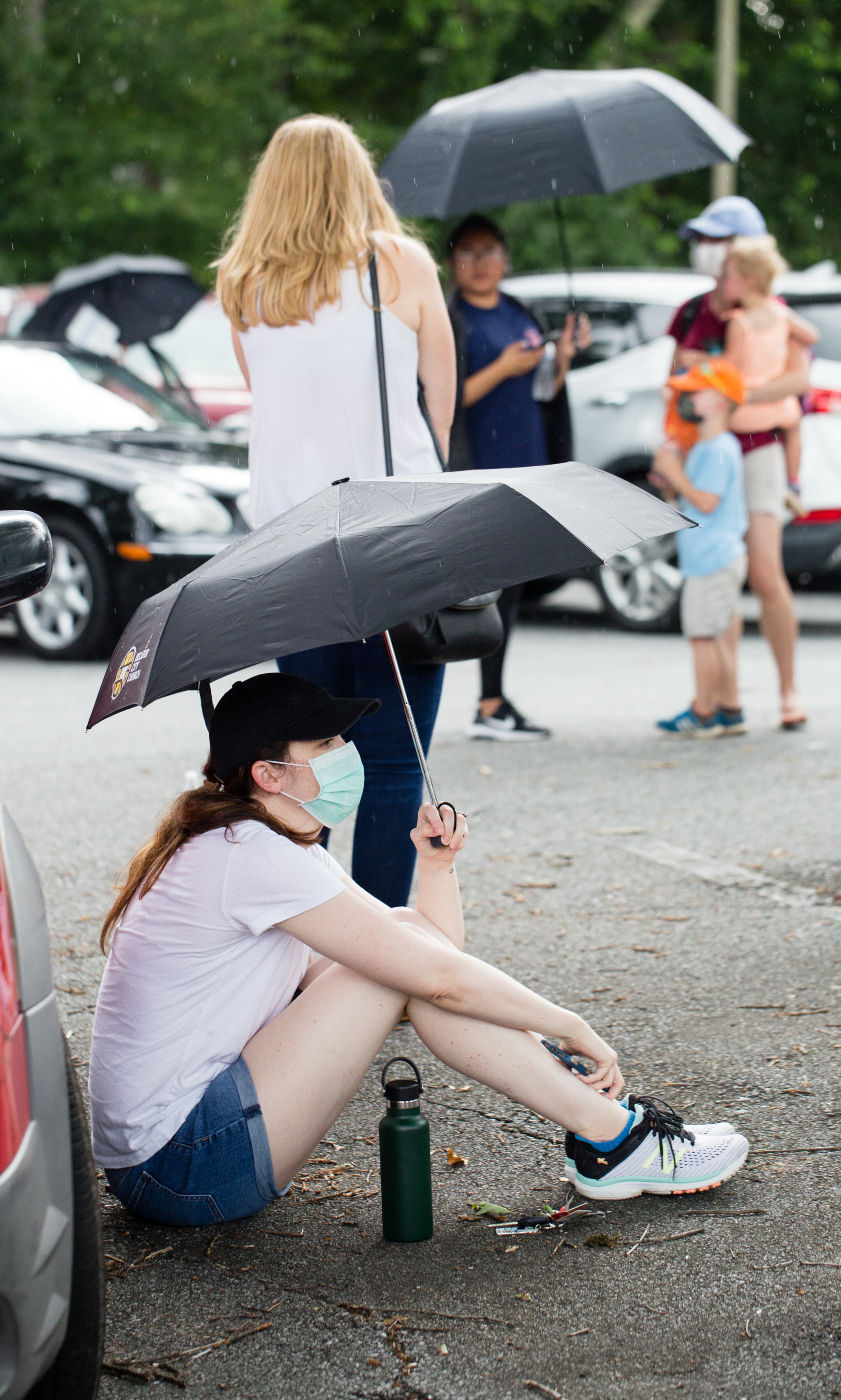 Voters wait in long lines, at times in the rain, at New Beginnings Full Gospel Church on Tuesday, June 9, 2020. The lines were taking more than 3.5 hours. This polling location opened at 7 am with only one machine of the four available working and had two of the four working at 4:30 and were not providing provisional ballots. (Jenni Girtman for The Atlanta Journal-Constitution)
