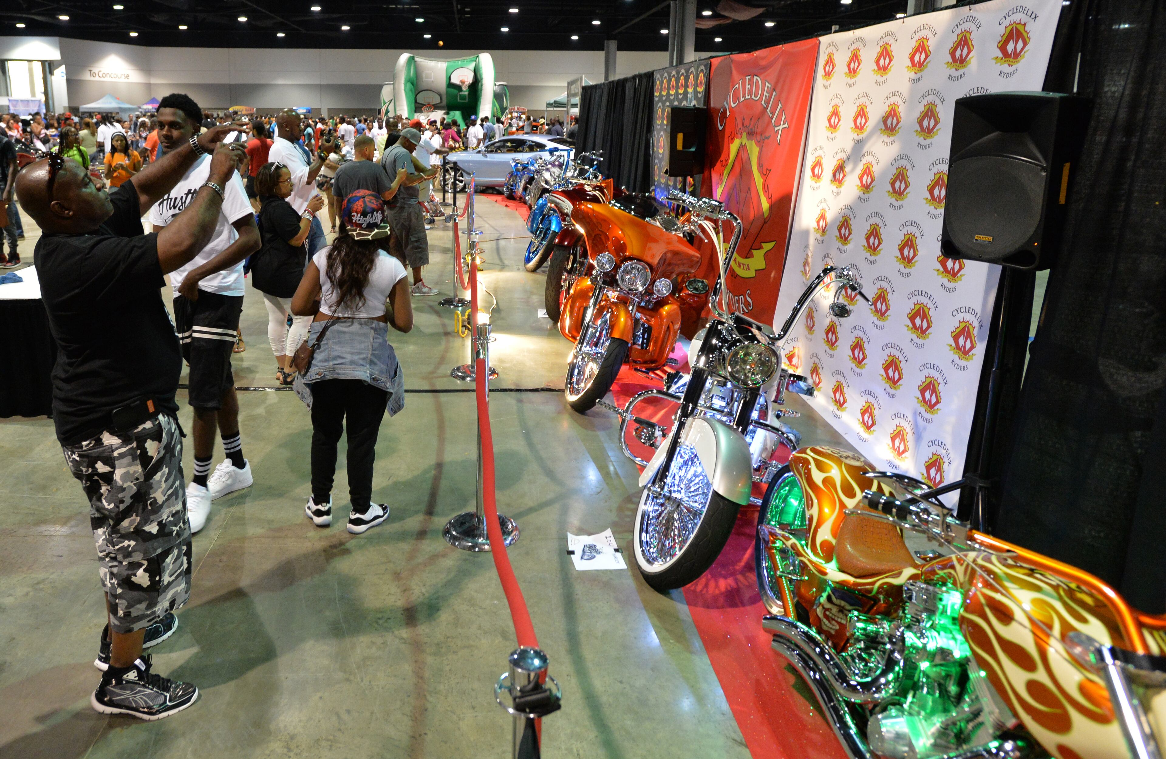 Event-goers take pictures of custom bikes during The 2014 V-103/WAOK Car & Bike Show at the Georgia World Congress Center on Saturday, July 12, 2014.