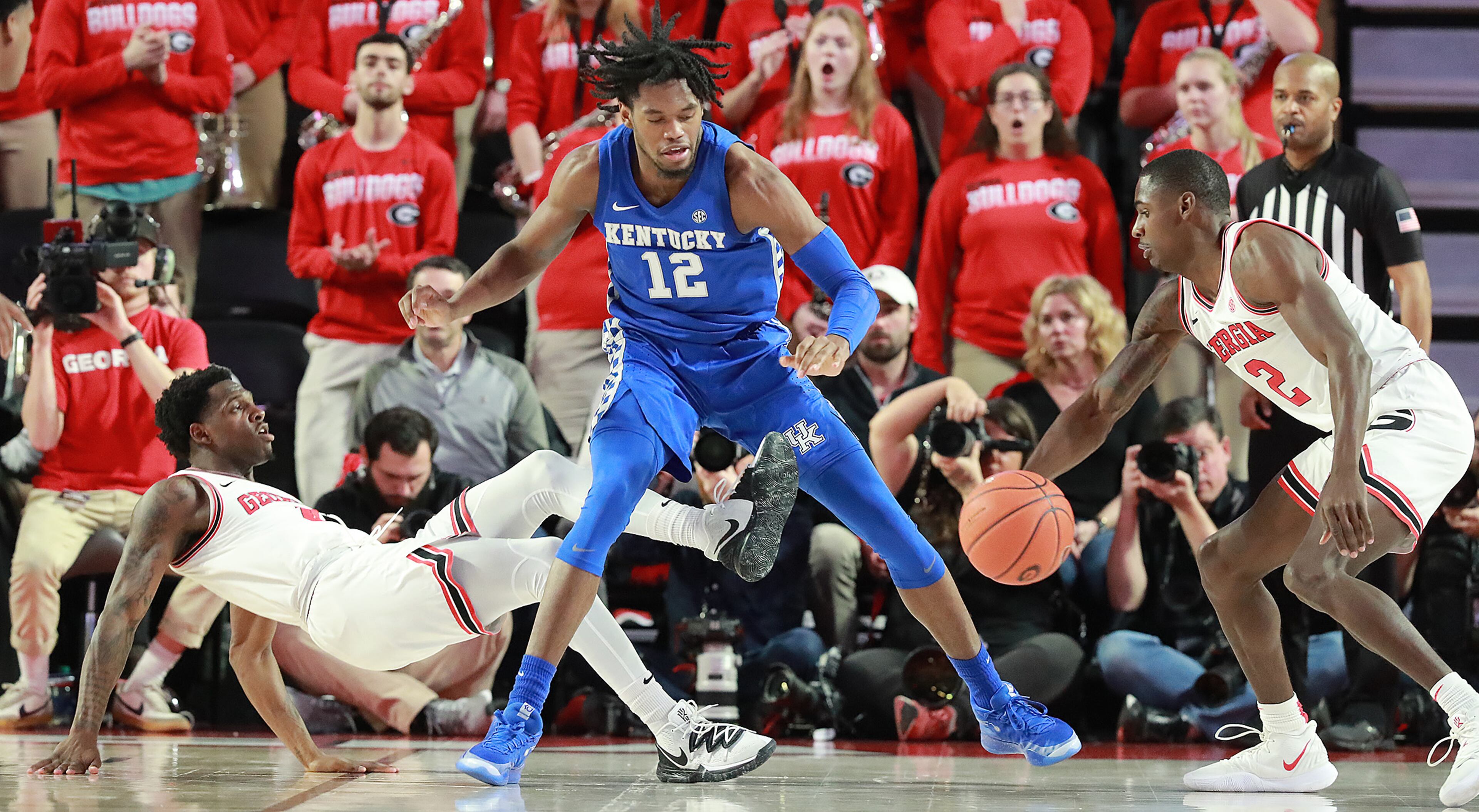Kentucky forward Keion Brooks Jr. knocks Georgia senior Tyree Crump to the hardwood but at the same time Georgia senior Jordan Harris makes the steal during the first half in a NCAA college basketball game on Tuesday, January 7, 2020, in Athens. Curtis Compton ccompton@ajc.com
