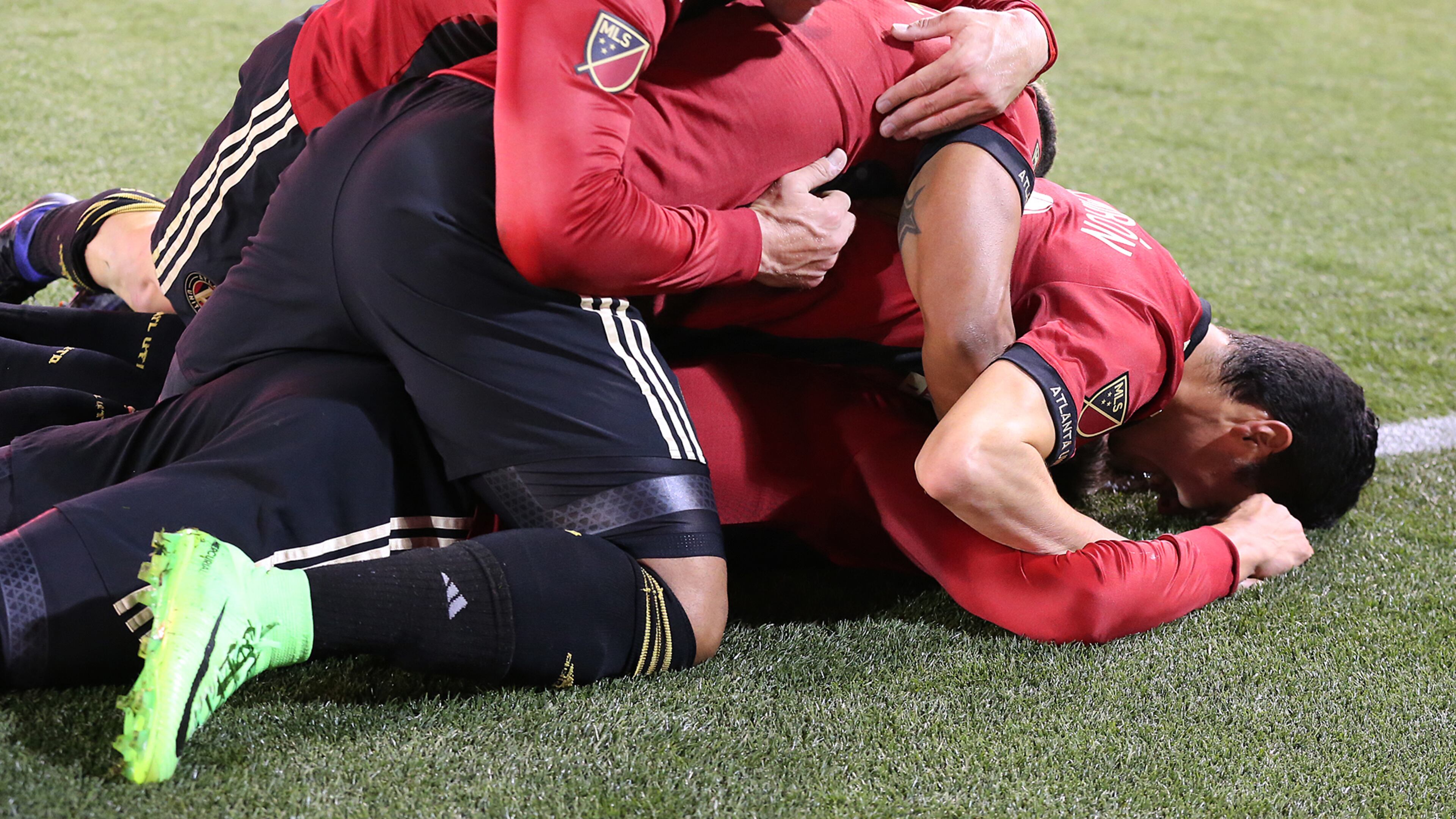 March 5, 2017, Atlanta: Atlanta United FC players pile on top of Yamil Asad after he scored the team’s first goal for a 1-0 lead against the N.Y. Red Bulls during the first game in franchise history on Sunday, March 5, 2017, in Atlanta. Curtis Compton/ccompton@ajc.com