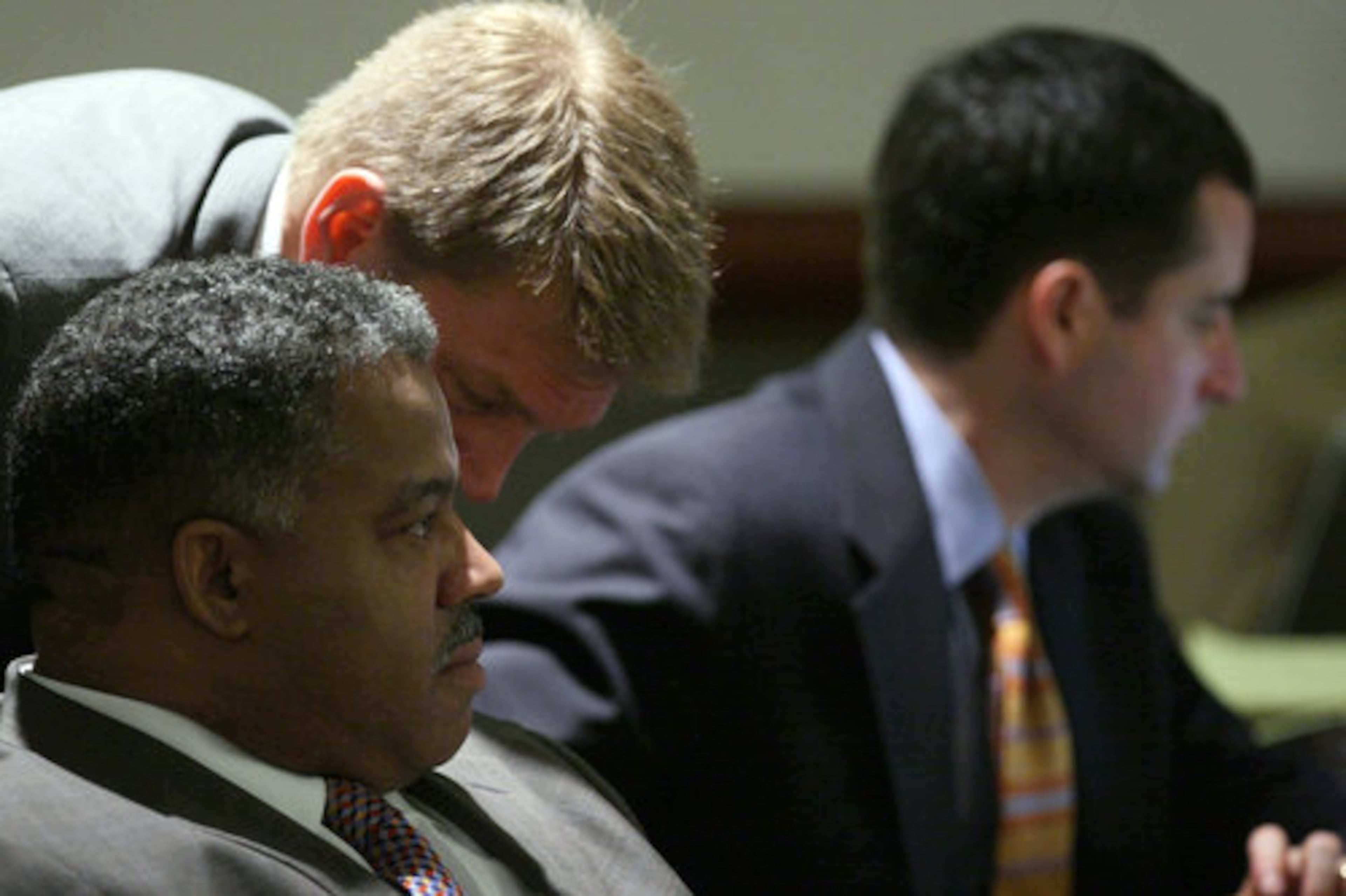 Brian Nichols' defense team members Robert McGlasson (center) and Henderson Hill (left) huddle during opening arguments Monday.