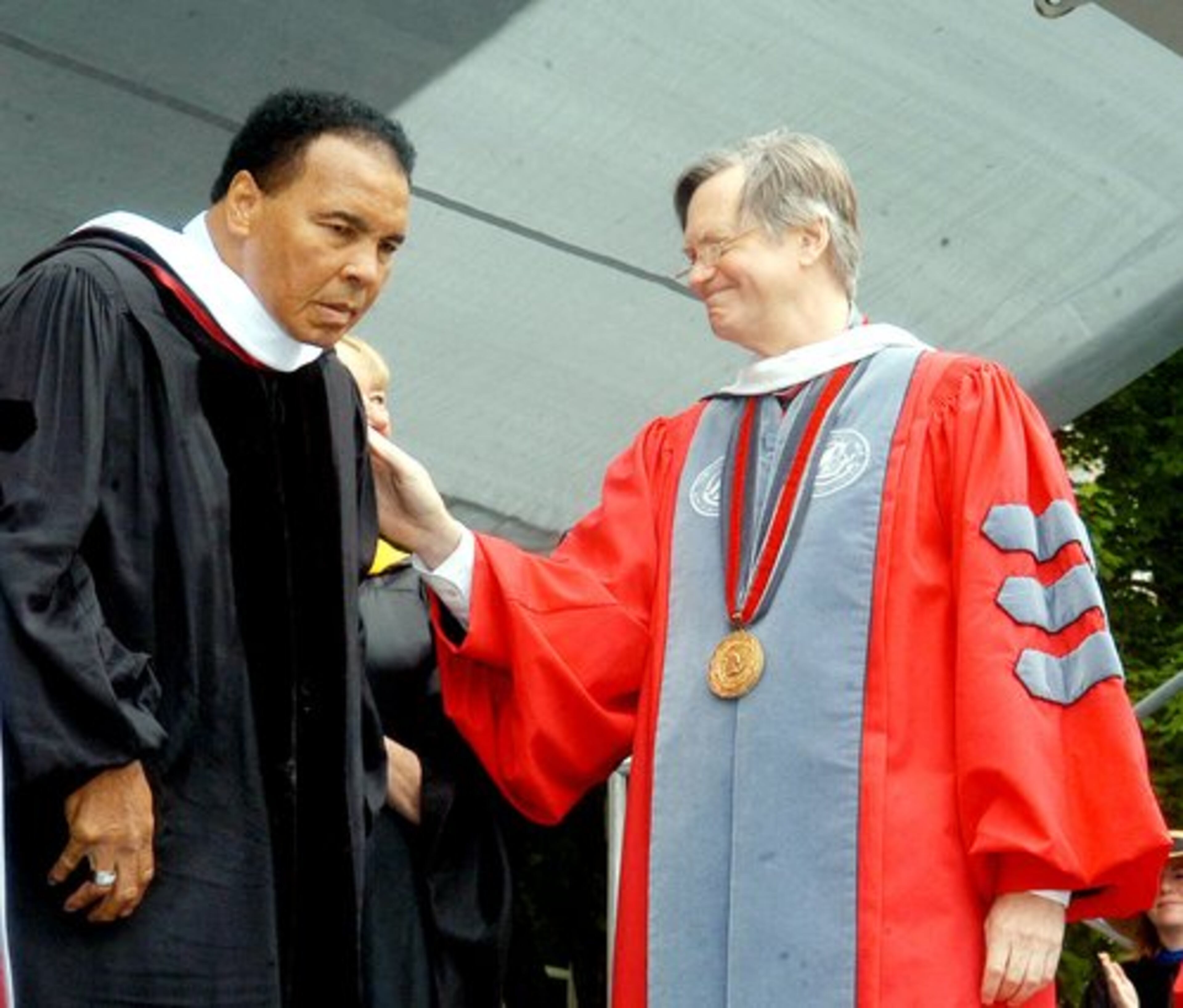 Former world boxing champion Muhammad Ali is congratulated by Muhlenberg College president Peyton Helm after being awarded a doctor of humane letters honorary degree at Muhlenberg College in Allentown, Pa.