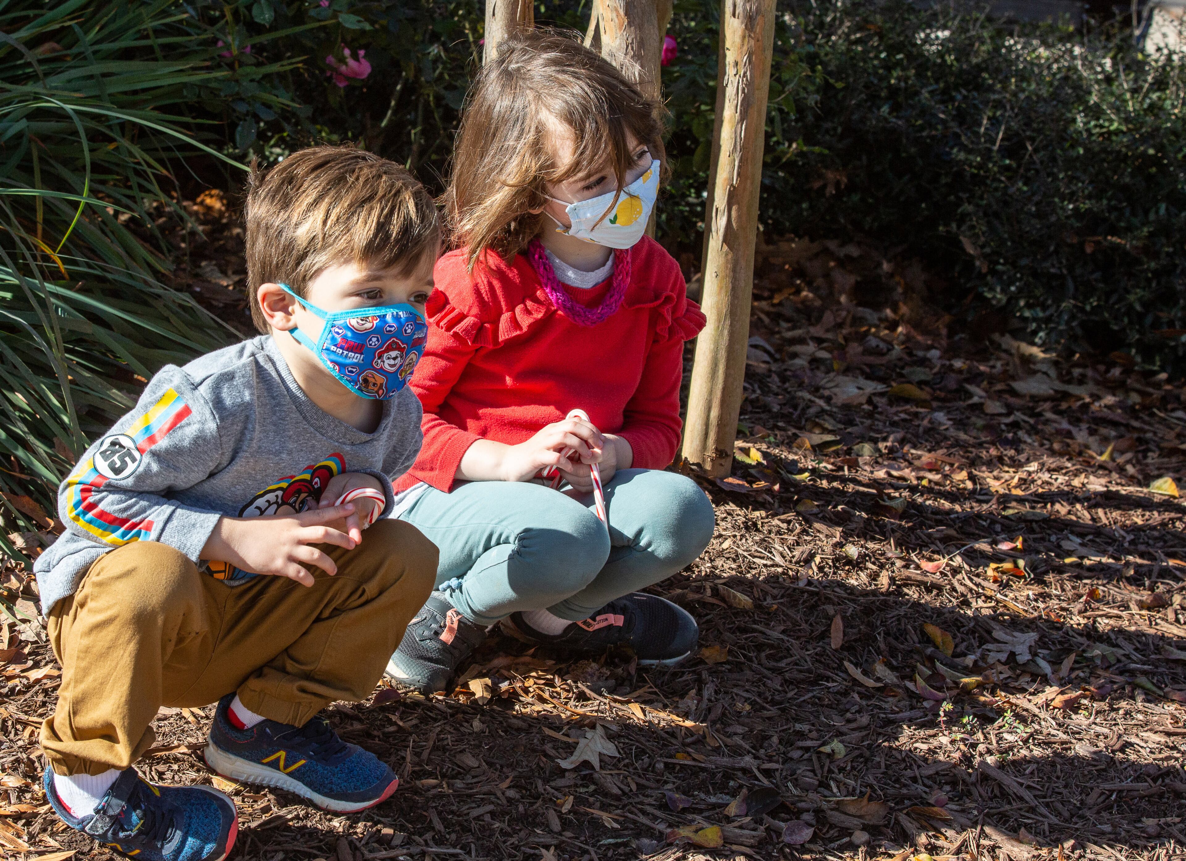 Victor (left) and Violet Gomez wait for Santa to drive by in a firetruck on Oakview Drive in Decatur during the city's Small Business Saturday shopping and festivities on November 28, 2020. (Photo: Steve Schaefer for The Atlanta Journal-Constitution)