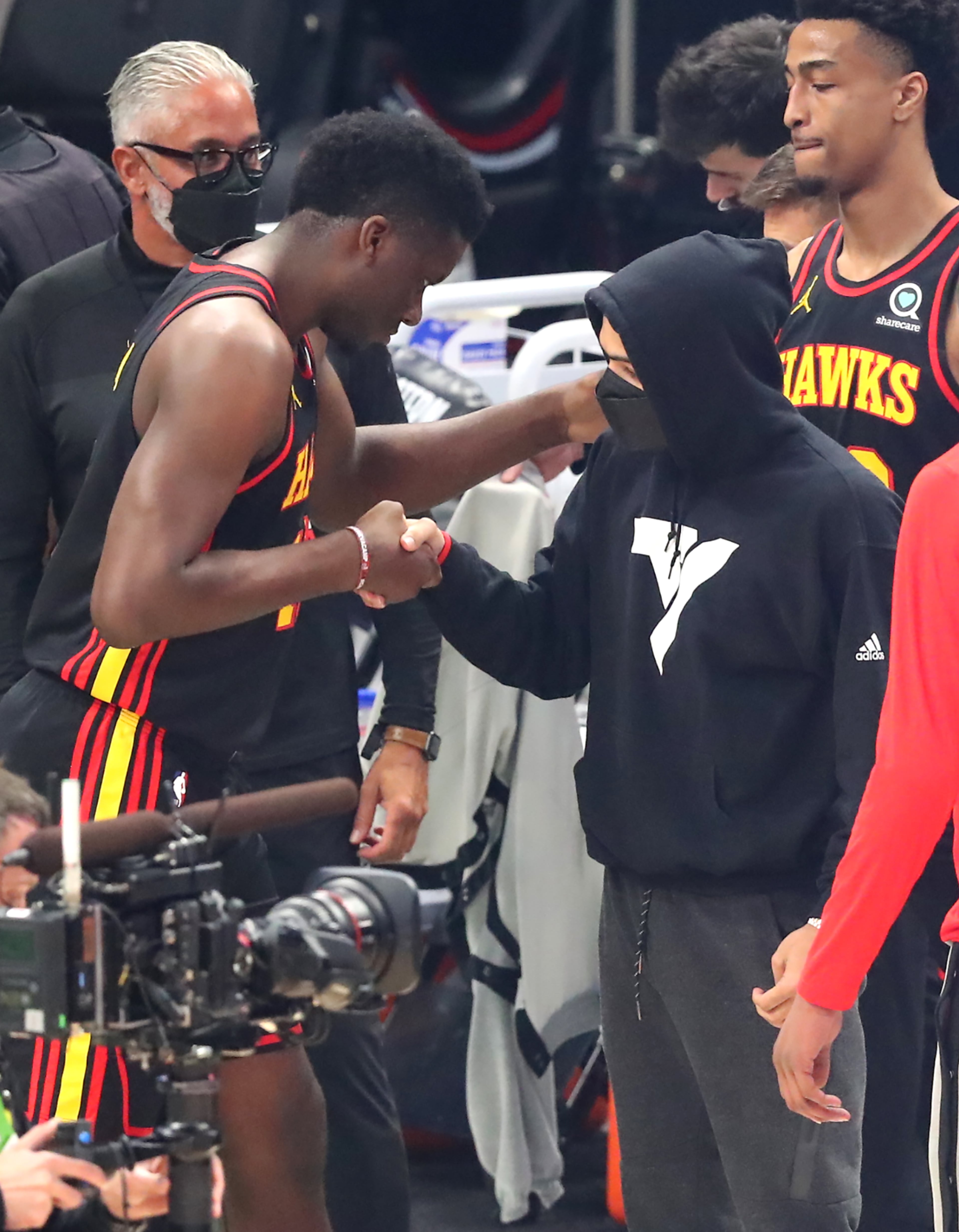Hawks guard Trae Young (right) encourages Clint Capela during the first quarter in game 5. “Curtis Compton / Curtis.Compton@ajc.com”
