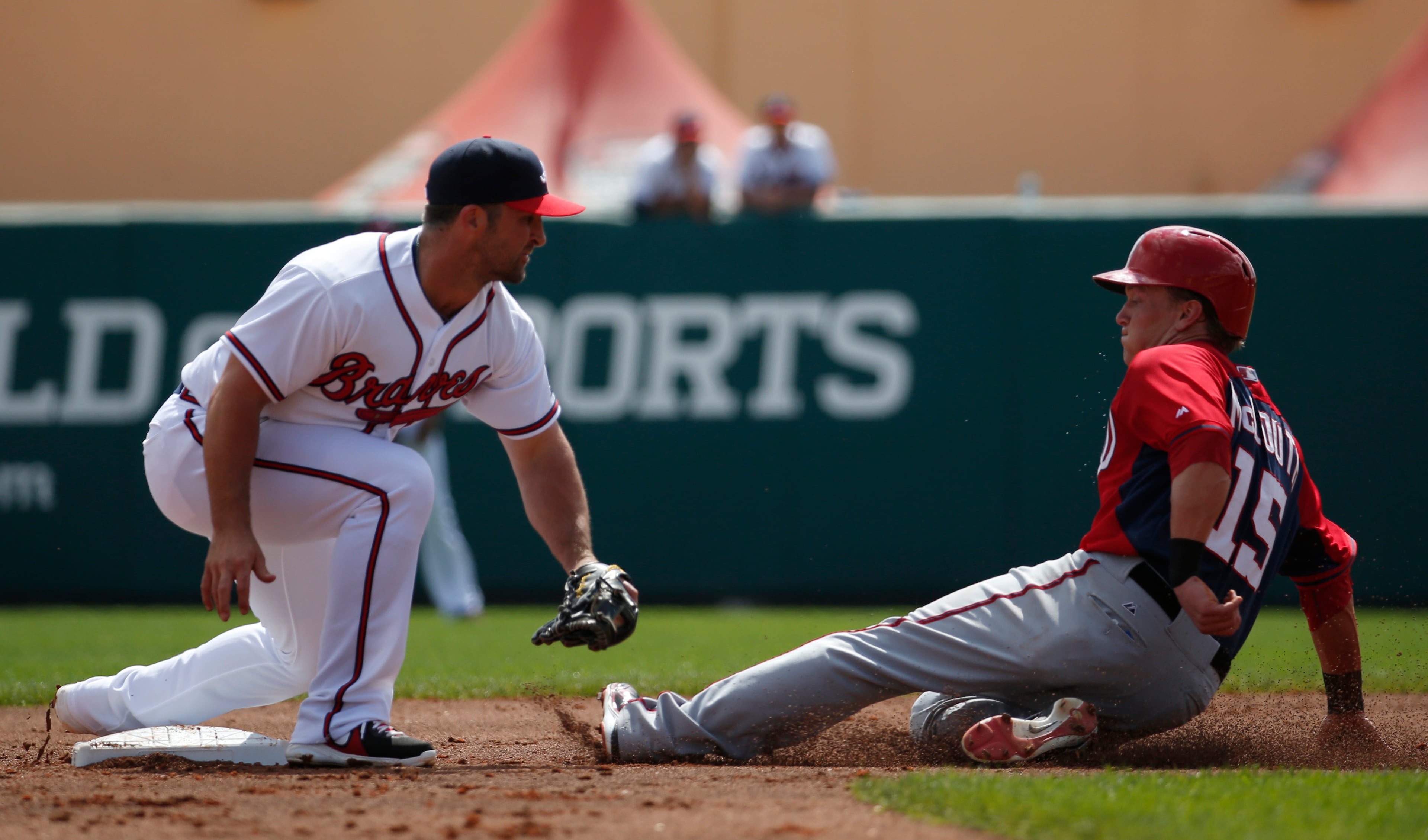 Atlanta Braves second baseman Dan Uggla (26) waits to make the tag on Washington Nationals' Nate McLouth (15) who was out at second on the steal attempt, in the third inning of a spring exhibition baseball game, Tuesday, March 4, 2014, in Kissimmee, Fla.