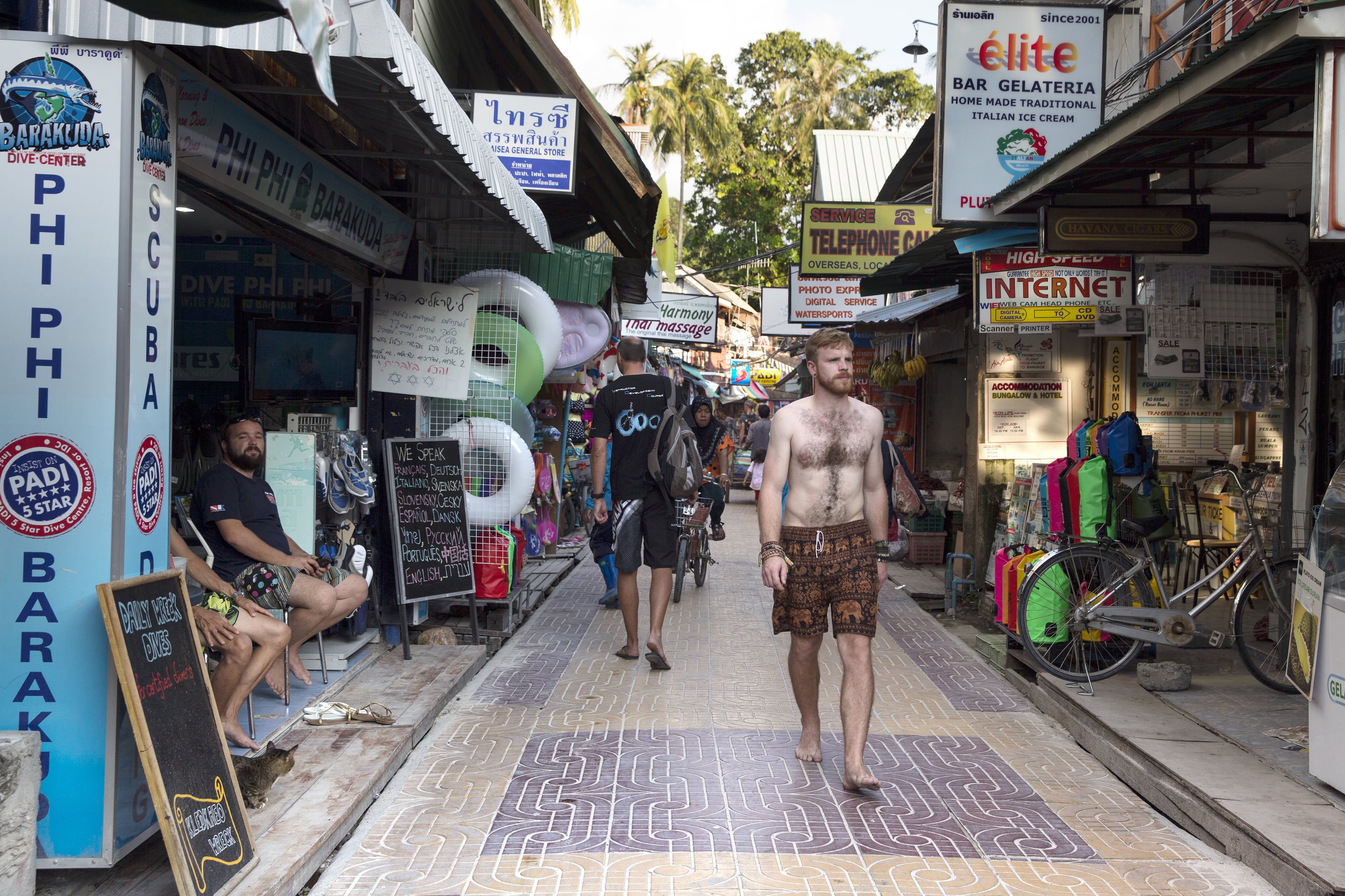 PHI PHI ISLAND, THAILAND - DECEMBER 12: A man walks between stores prior to the ten year anniversary of the 2004 earthquake and tsunami on December 12, 2014 in Phi Phi Village, Ton Sai Bay, Thailand. The tenth anniversary of the 2004 Indian Ocean earthquake and tsunami killing almost 250,000 people will be remembered on December 26. (Photo by Paula Bronstein/Getty Images)