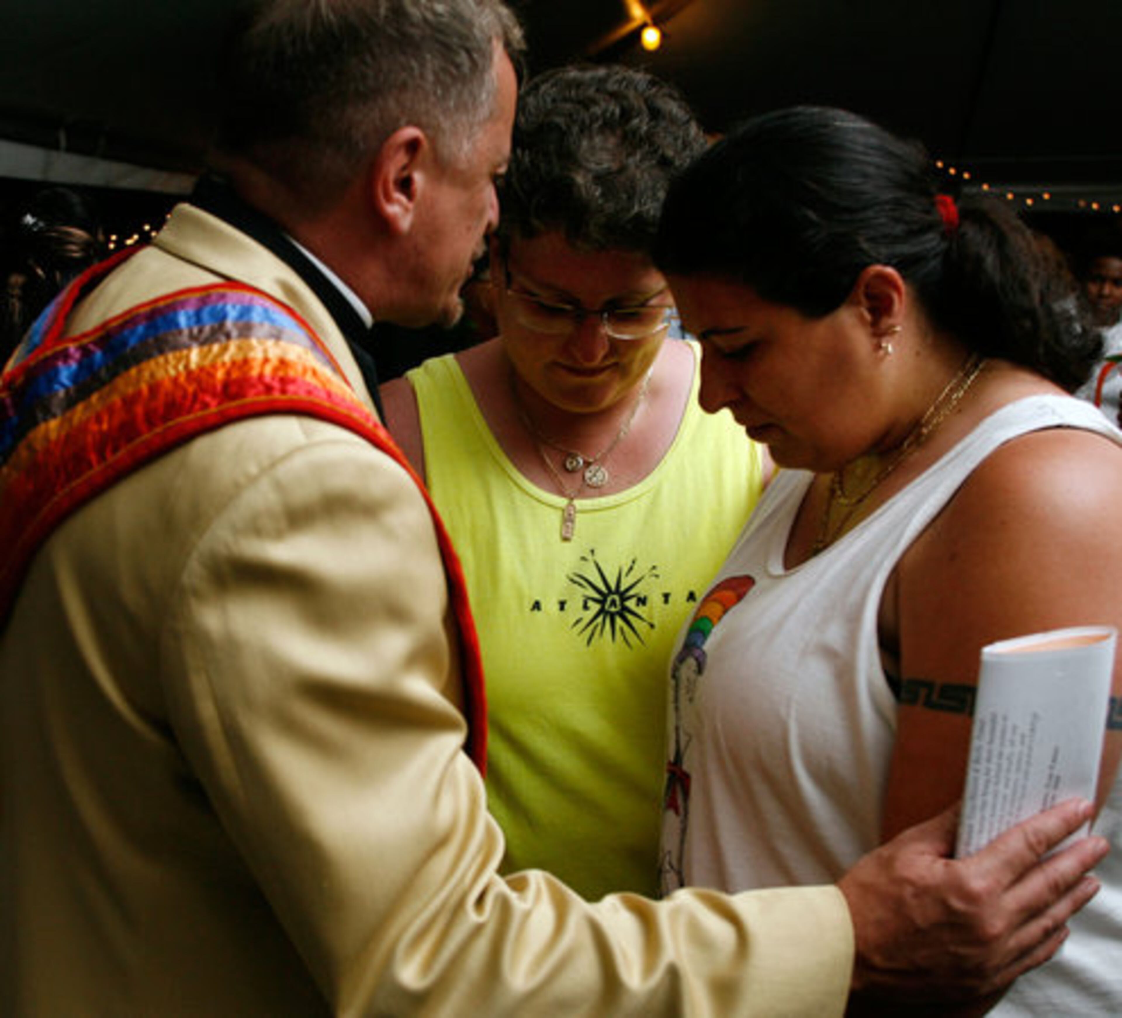 The Rev. Paul Graetz blesses the union of Bonnie Kohl and Maria Vinson during the Atlanta Pride Festival's commitment ceremony. The couple have been together for nine years.