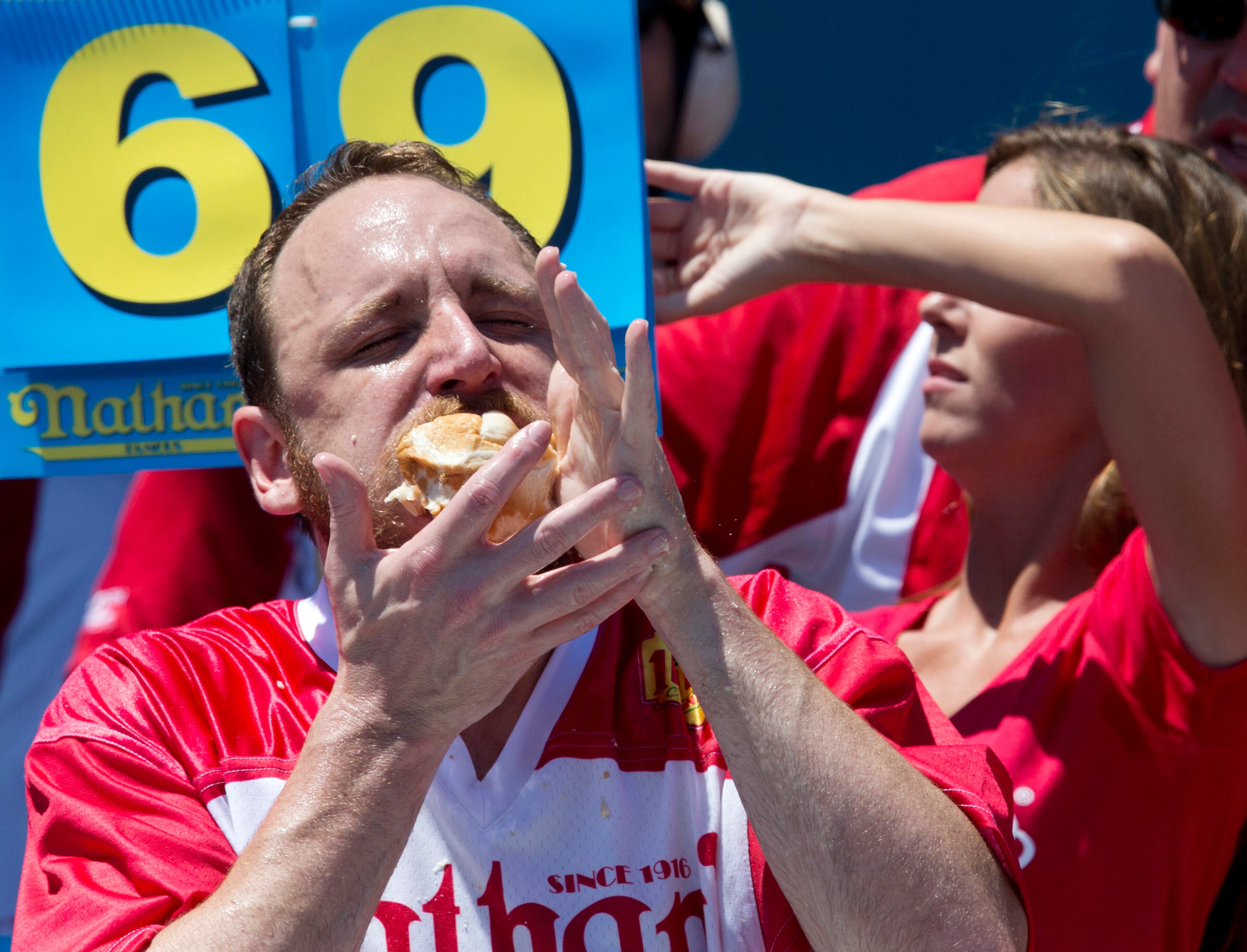 Joey Chestnut competes in Nathan's Famous Fourth of July International Hot Dog Eating Contest men's competition, Monday, July 4, 2016, in New York. Chestnut came in first eating 70 hot dogs and buns in 10 minutes. (AP Photo/Mary Altaffer)