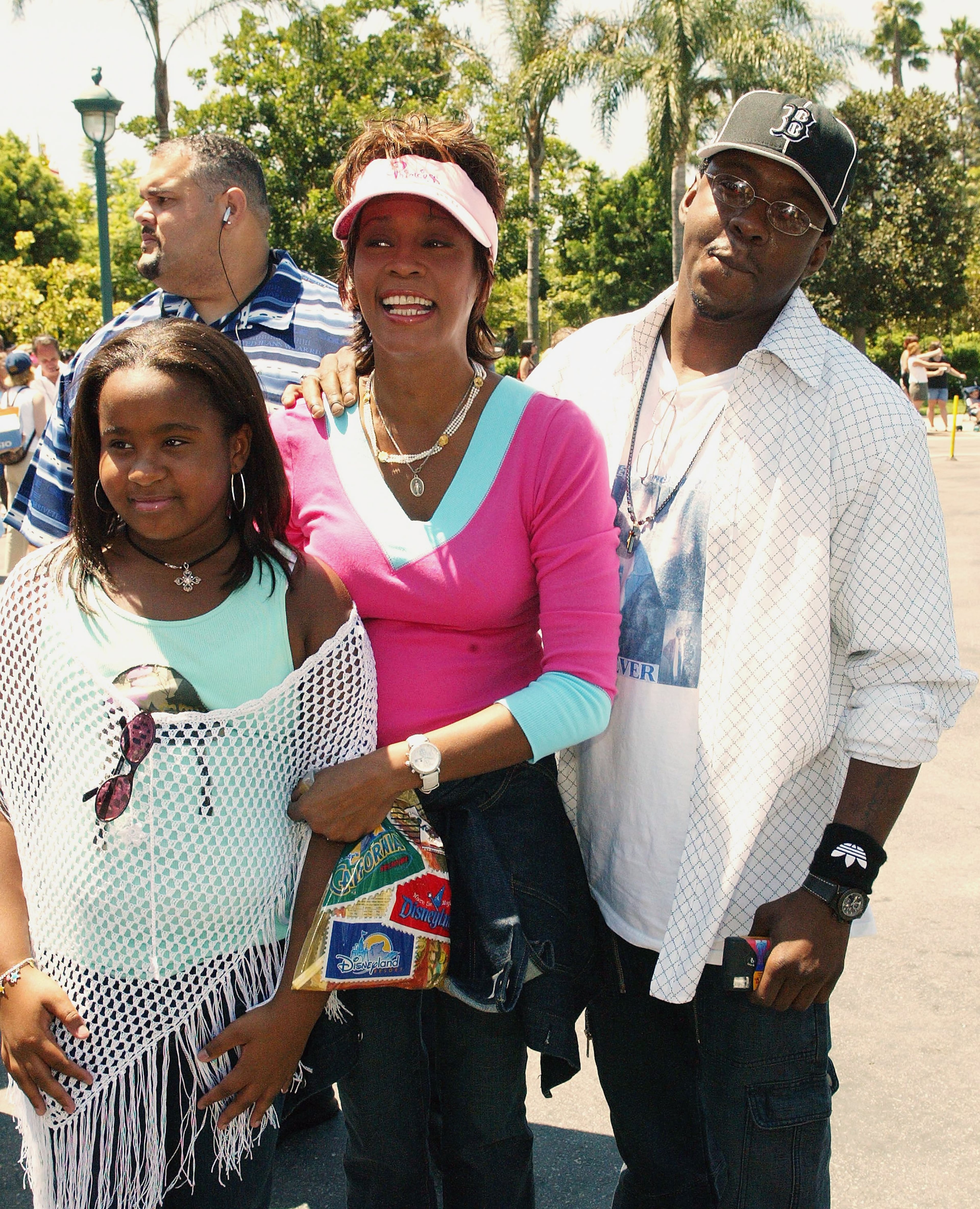 Producer/recording artist Whitney Houston (C) and recording artist Bobby Brown and family attend the film premiere of "The Princess Diaries 2: Royal Engagement" at Disneyland on August 7, 2004 in Anaheim, California. The film "The Princess Diaries 2: Royal Engagement" opens in theaters nationwide on August 11, 2004. (Photo by Frederick M. Brown/Getty Images).
