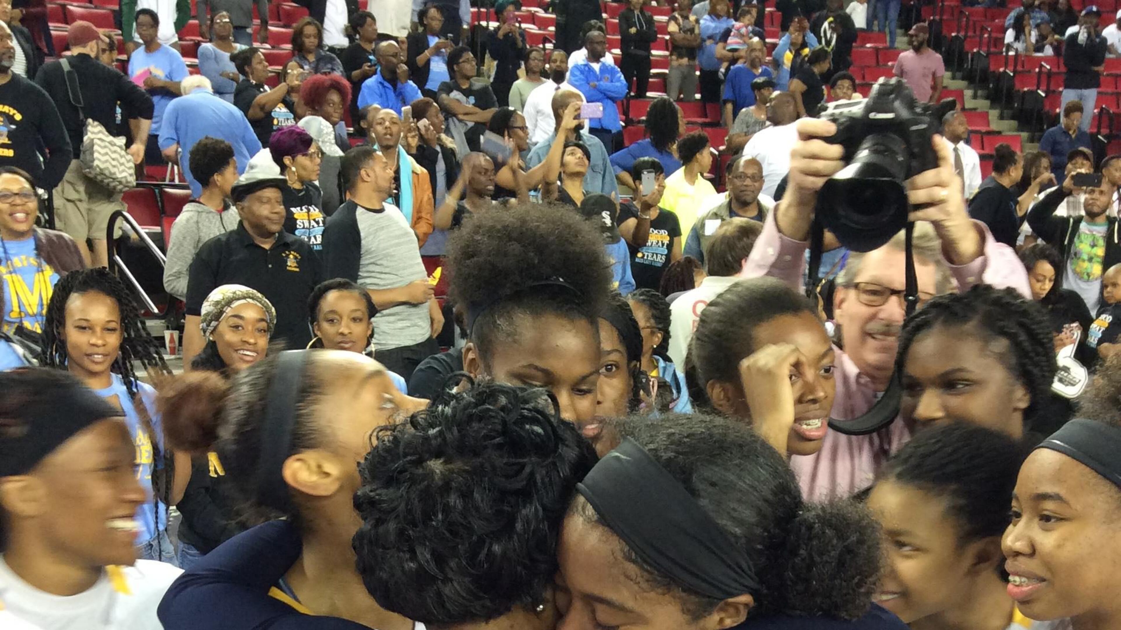 Mays coach Chantay Frost celebrates with players after their 52-51 victory over Harrison in the Class AAAAAA championship game at Stegeman Coliseum.