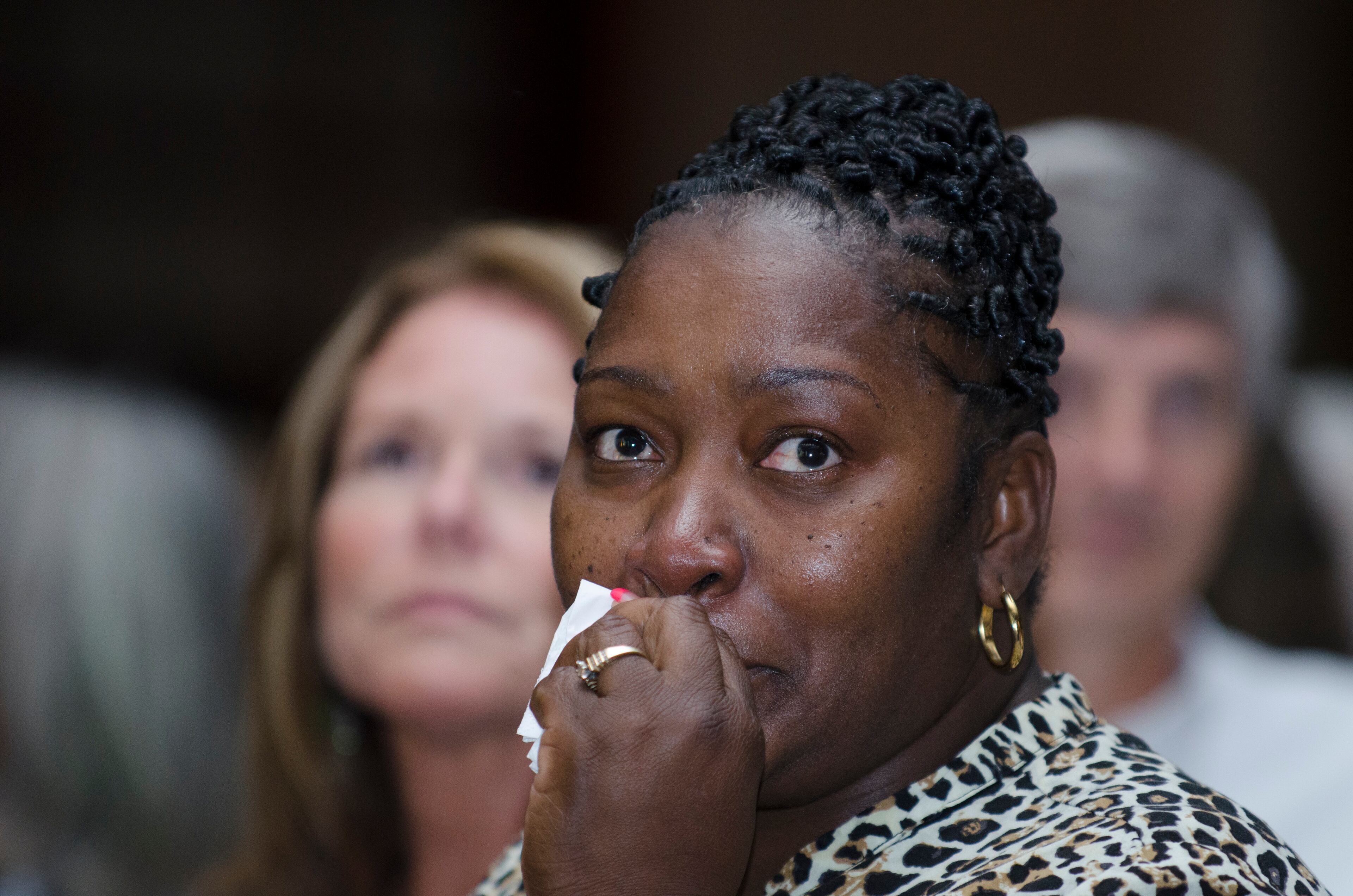 A member of Sherry King's table watches a documentary video during Celebrating Nurses AJC Jobs Nursing Excellence Awards Tuesday, May 6, 2014 at the Cobb Galleria. (Photo by Barry Williams/Special)