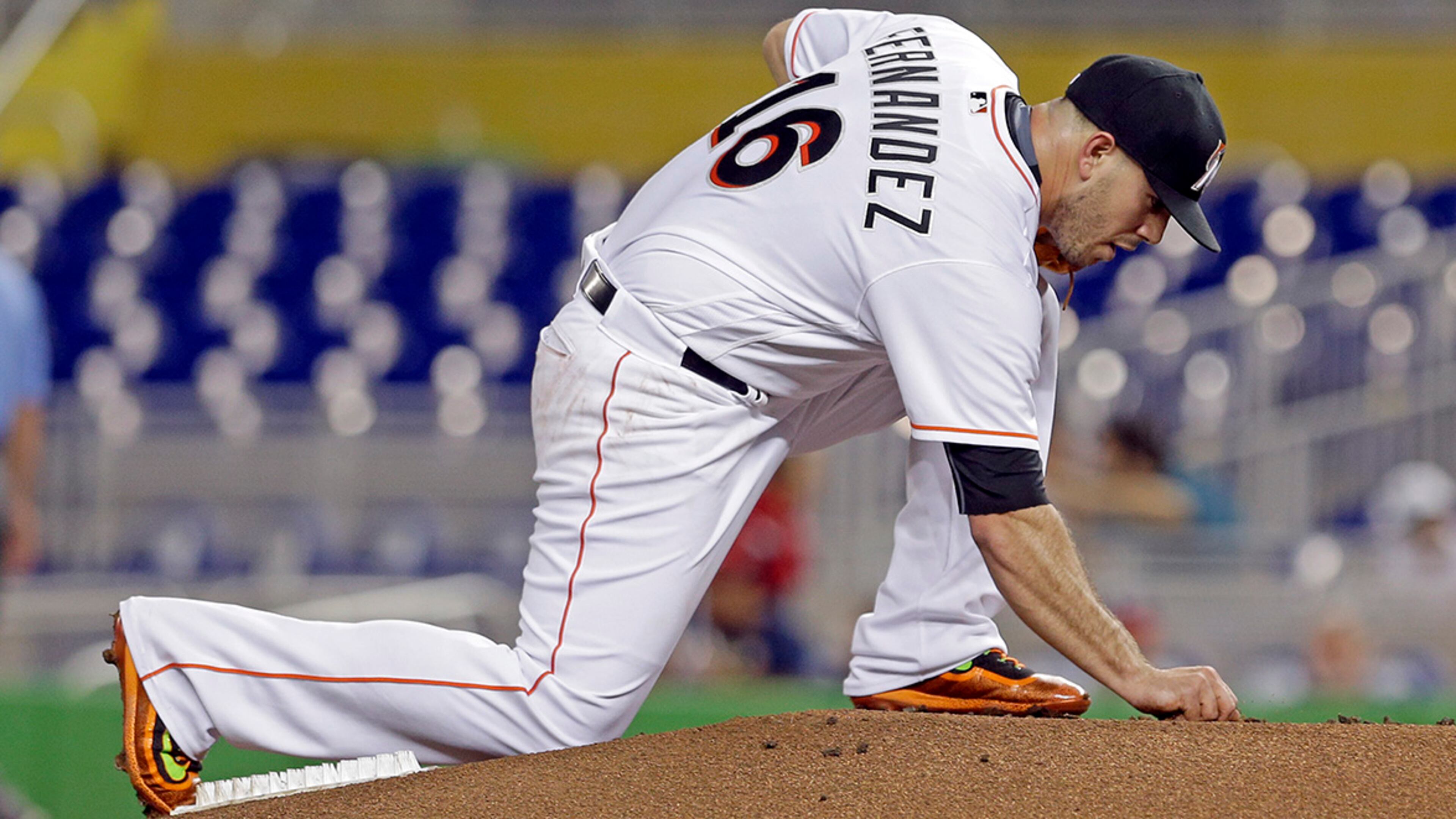 Miami Marlins' Jose Fernandez grabs some dirt before a baseball game against the Washington Nationals, Tuesday, Sept. 20, 2016, in Miami. Fernandez's death has transcended baseball.