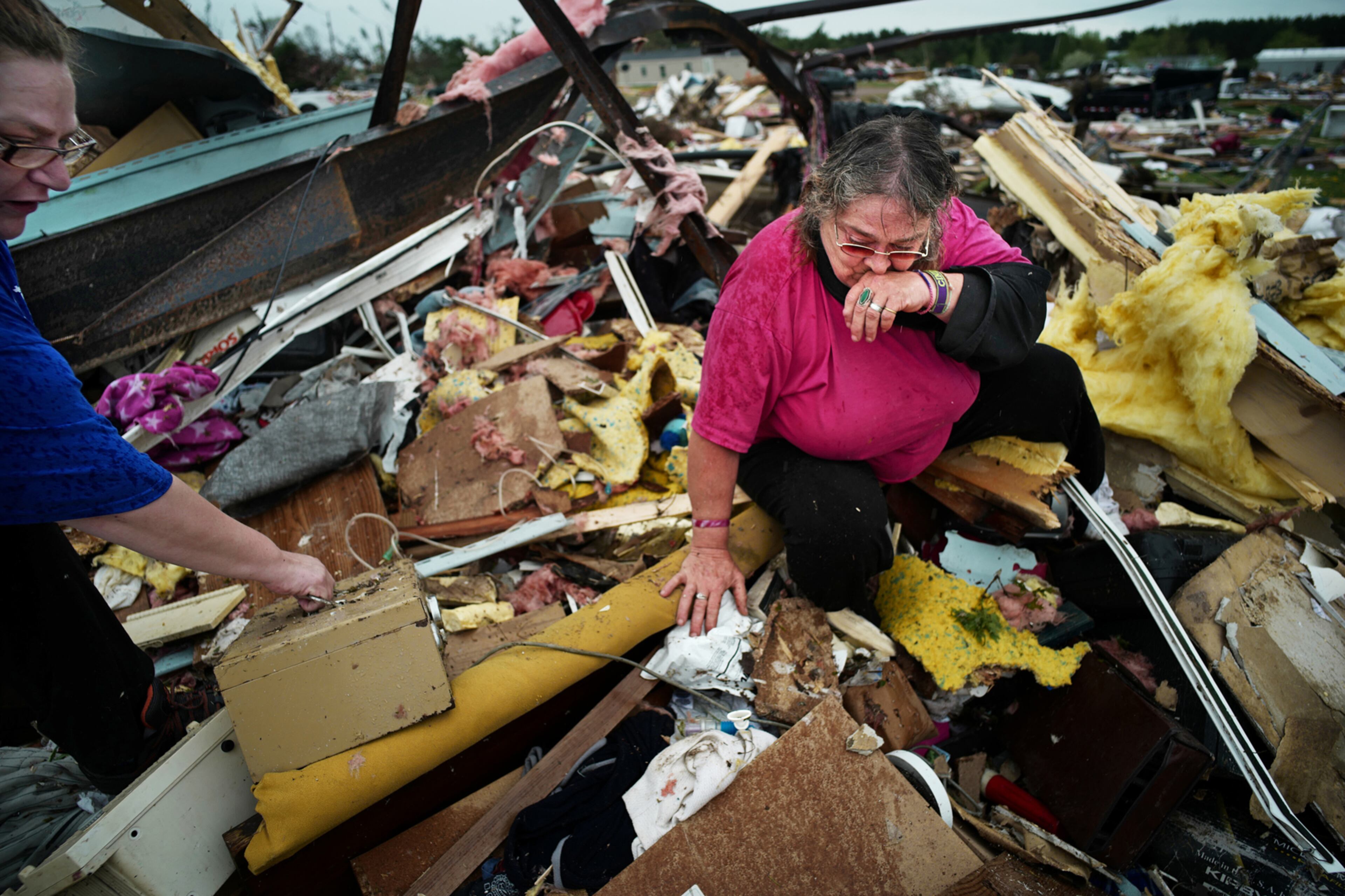 Cindy Rutledge and her daughter Mary, right, search for her dachshund in the wreckage of her trailer home on May 17, 2017 in Chetek, WIs. .The tornado flattened a trailer park and nearby trees. One person died and at least 25 were injured. (Richard Tsong-Taatarii/Minneapolis Star Tribune/TNS)
