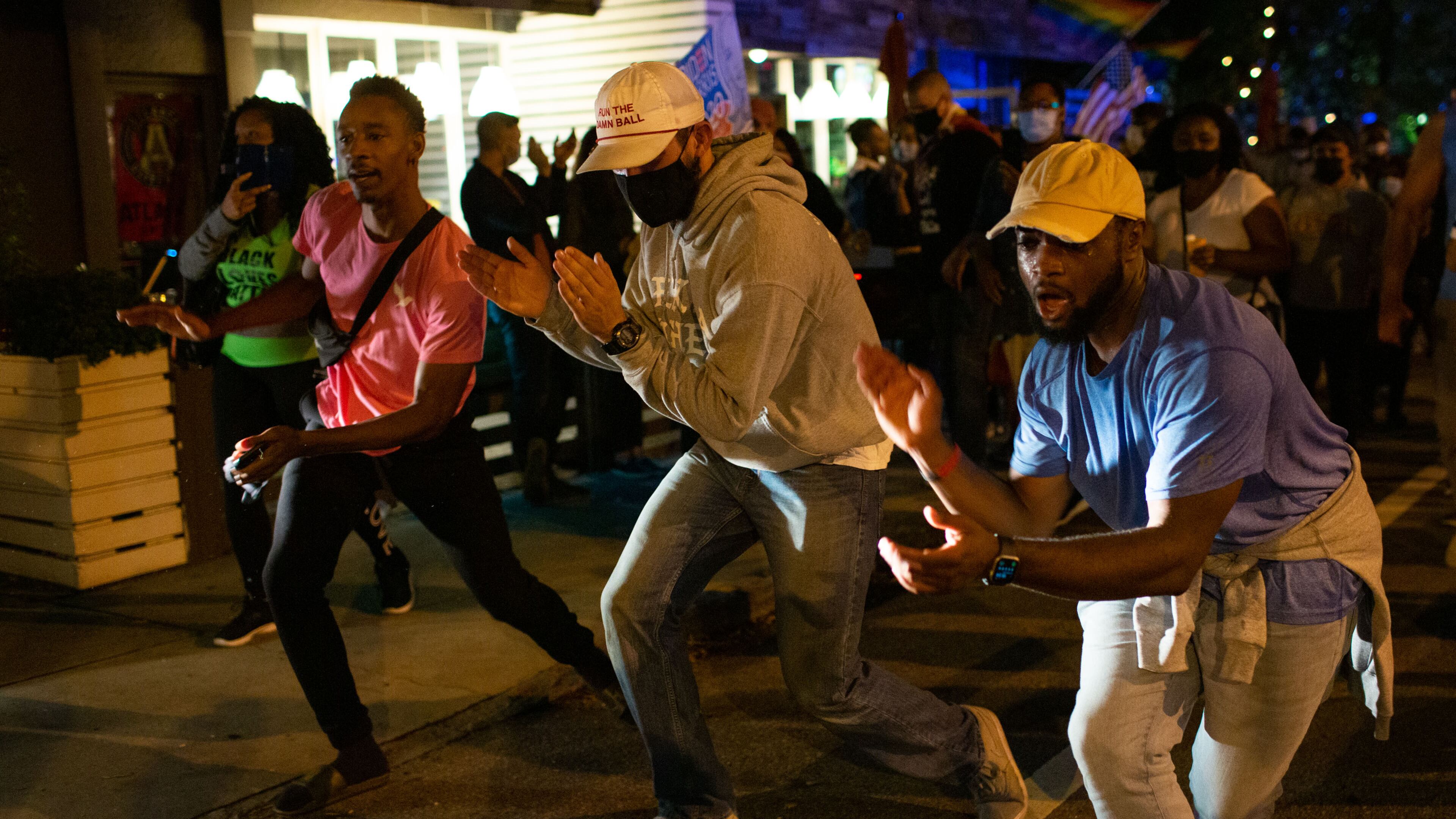 People dance in the streets to celebrate President-elect Joe Biden’s victory over Donald Trump in the U.S. general election in Midtown Atlanta, on Saturday, Nov. 7, 2020. (Rebecca Wright for The Atlanta Journal-Constitution)