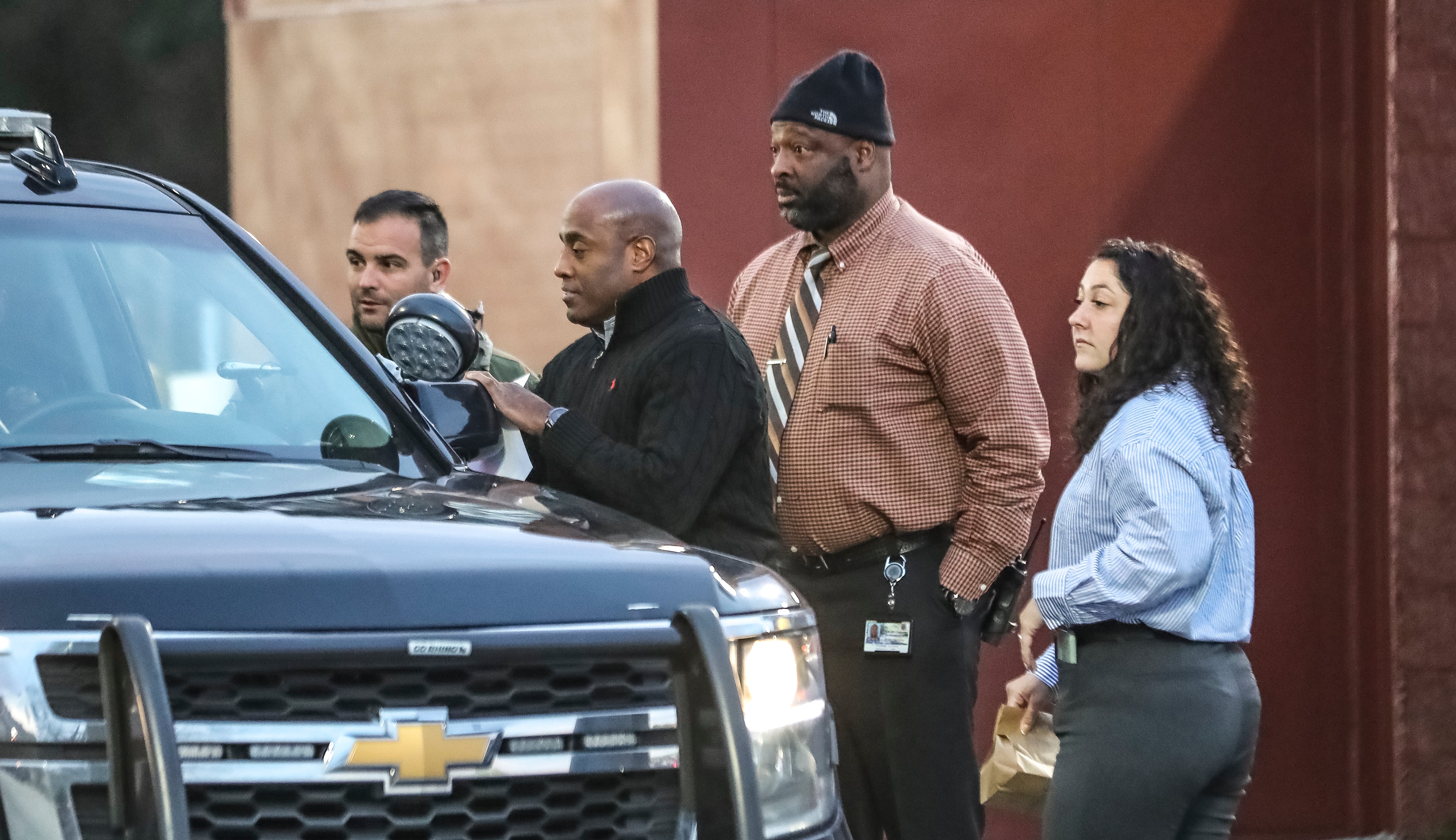 Police detectives discuss their investigation into a shooting at a Waffle House in Tucker on Monday morning.