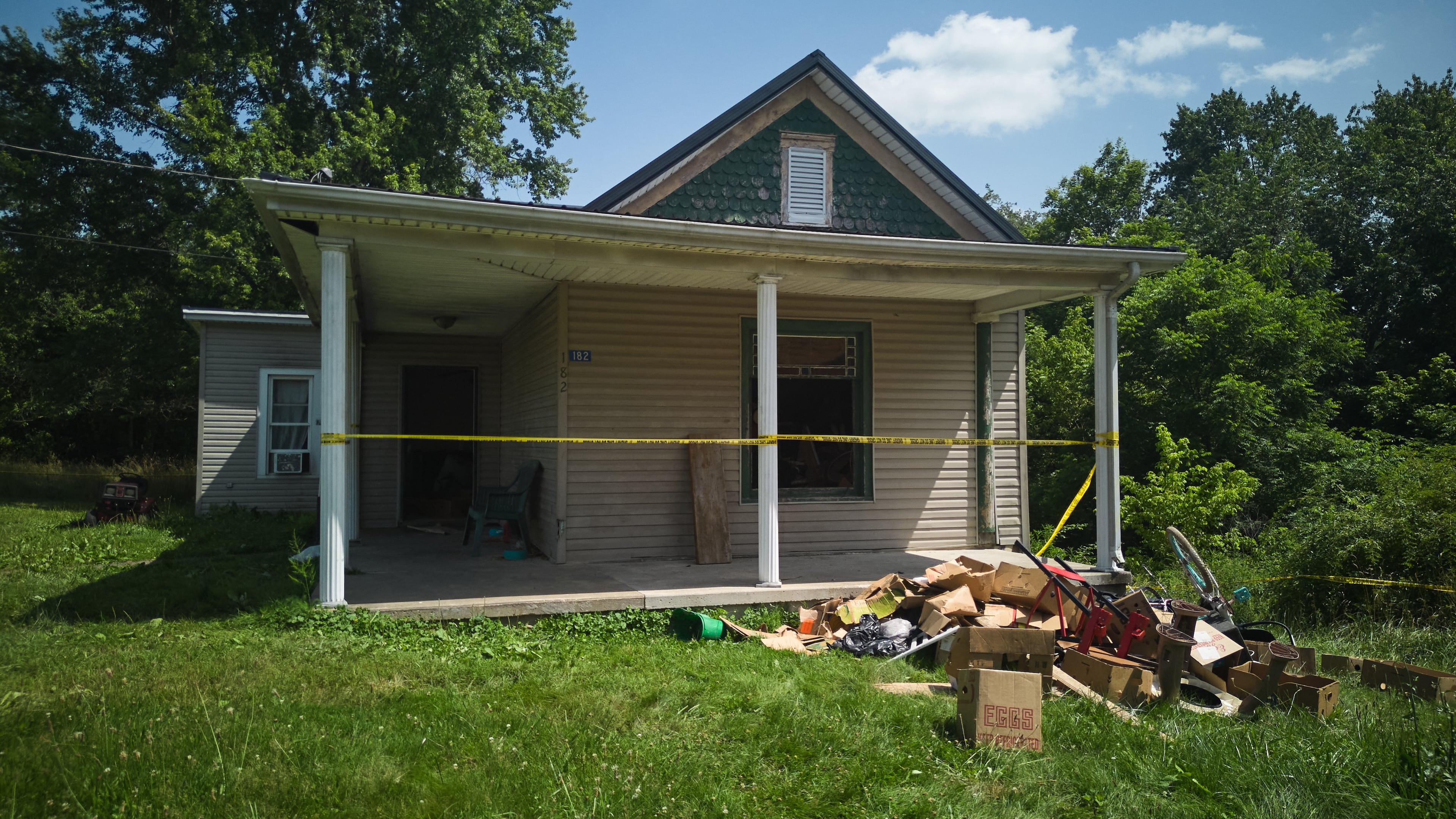 FILE - Police tape surrounds a home where authorities say they removed 16 children and arrested four adults in Hamden, Ohio, July 1, 2026. (AP Photo/Carolyn Kaster, File)