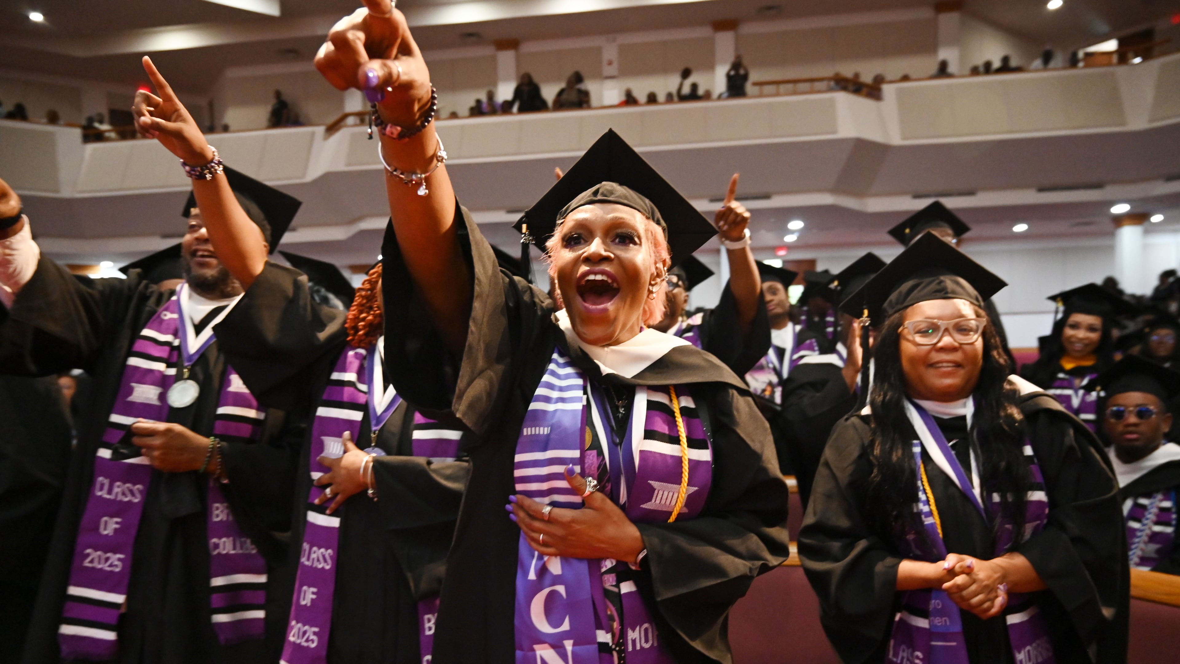 2025 Morris Brown graduates react as Bishop T.D. Jakes delivers a commencement address at Saint Philip A.M.E. Church last year. (Hyosub Shin/AJC)
