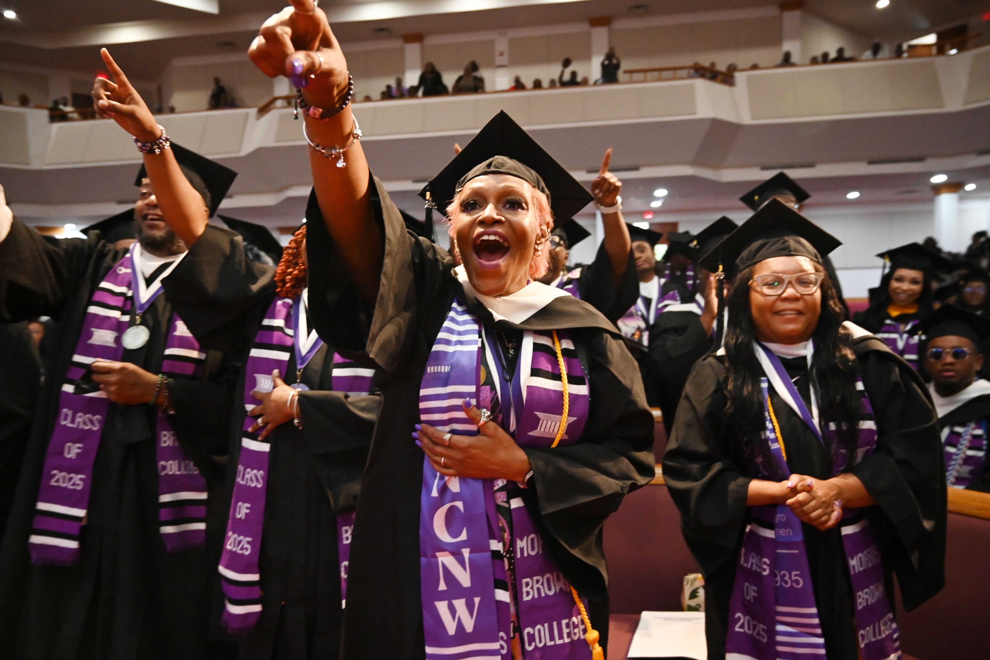 2025 Morris Brown graduates react as Bishop T.D. Jakes delivers a commencement address at Saint Philip A.M.E. Church last year. (Hyosub Shin/AJC)