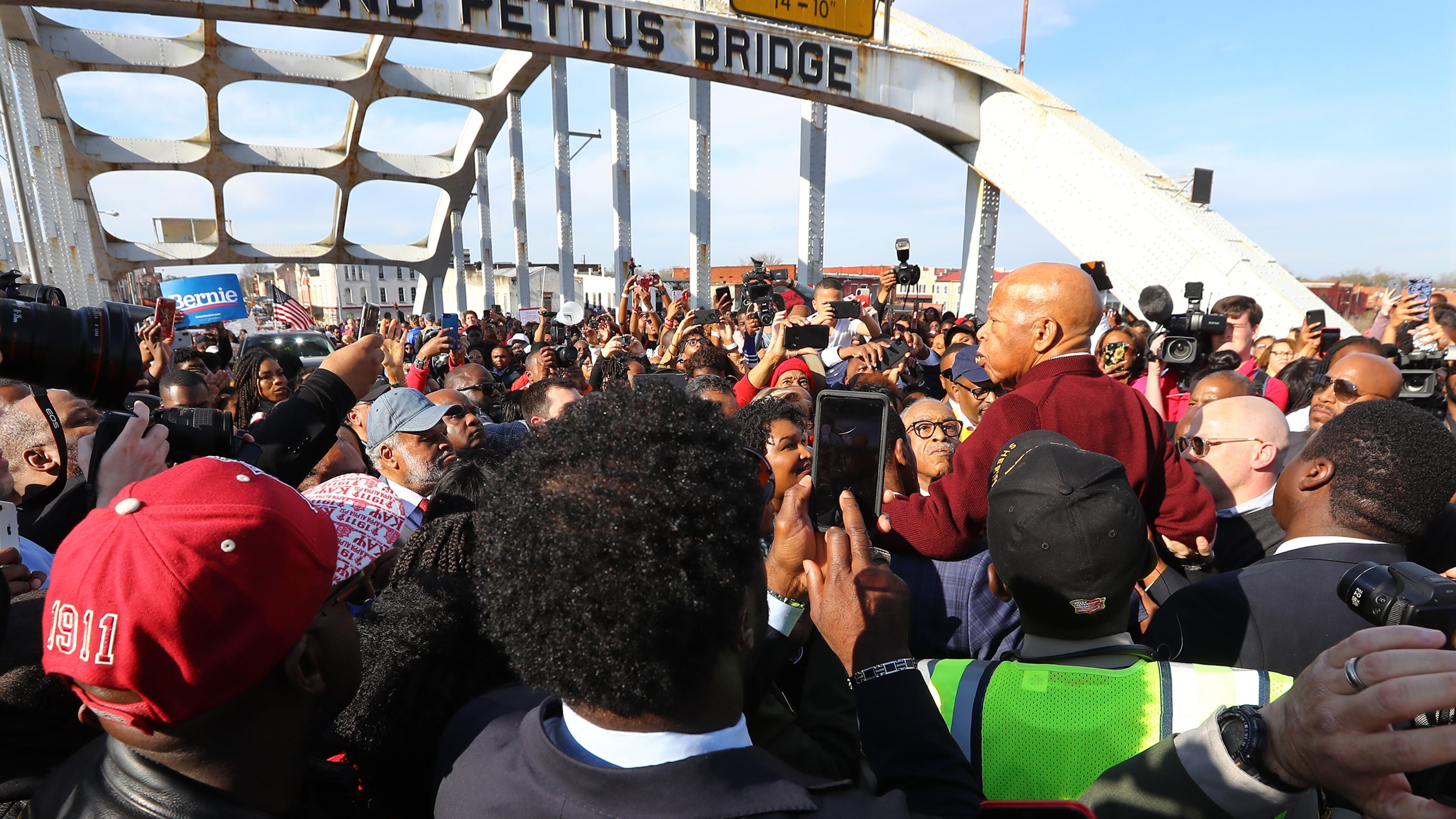 A group of men hoist U.S. Rep. John Lewis, D-Atlanta, on their shoulders so he can speak to the crowd of marchers at the Edmund Pettus Bridge during Selma's re-enactment of Bloody Sunday on Sunday, March 1, 2020, in Selma. Curtis Compton ccompton@ajc.com